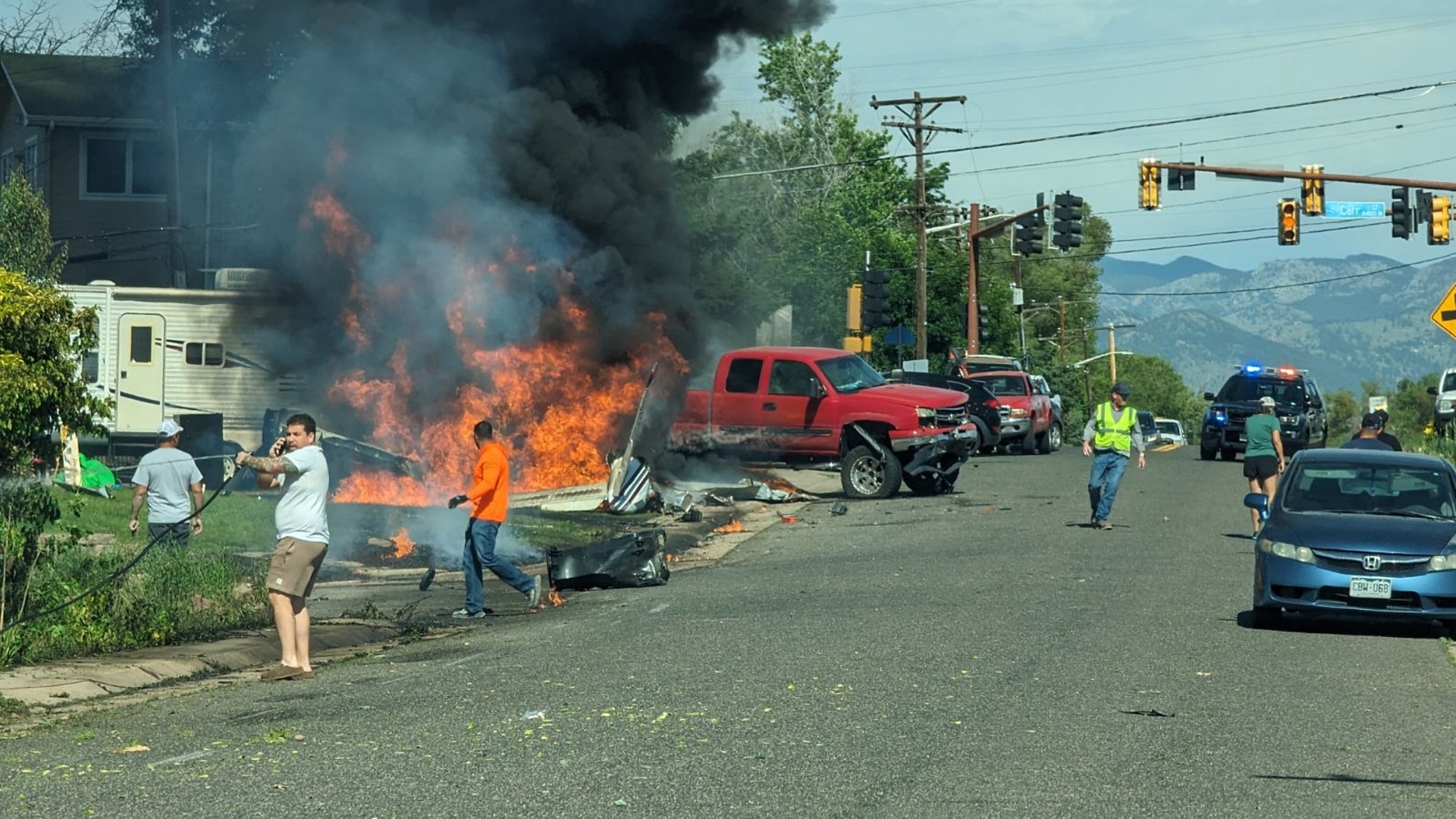 Neighbors respond to a fiery plane crash in Arvada on June 7, 2024. (Provided by Evan Sherlock via 9NEWS)