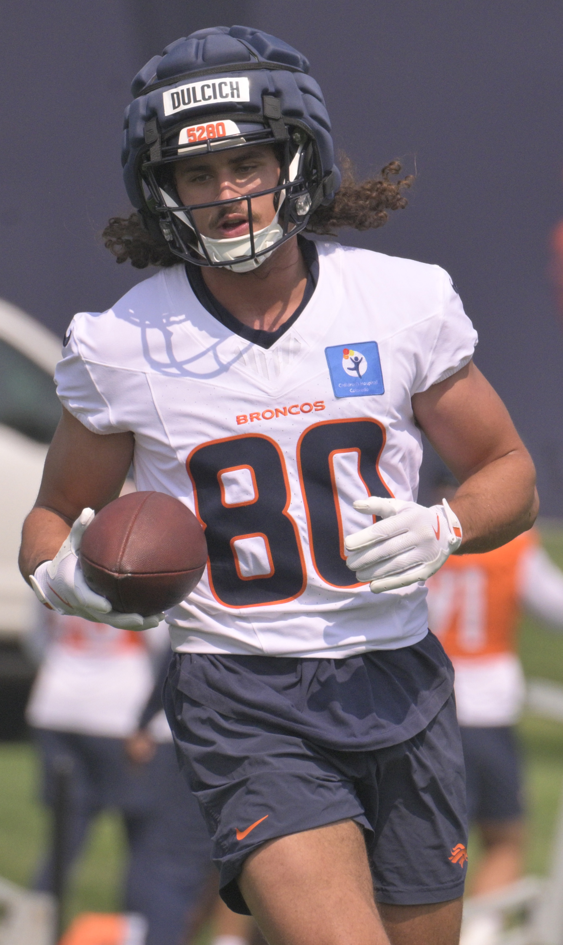 Broncos tight end Greg Dulcich carries the ball during practice at the Denver Broncos training center on Wednesday, July 24, 2024. (Jerilee Bennett The Gazette)