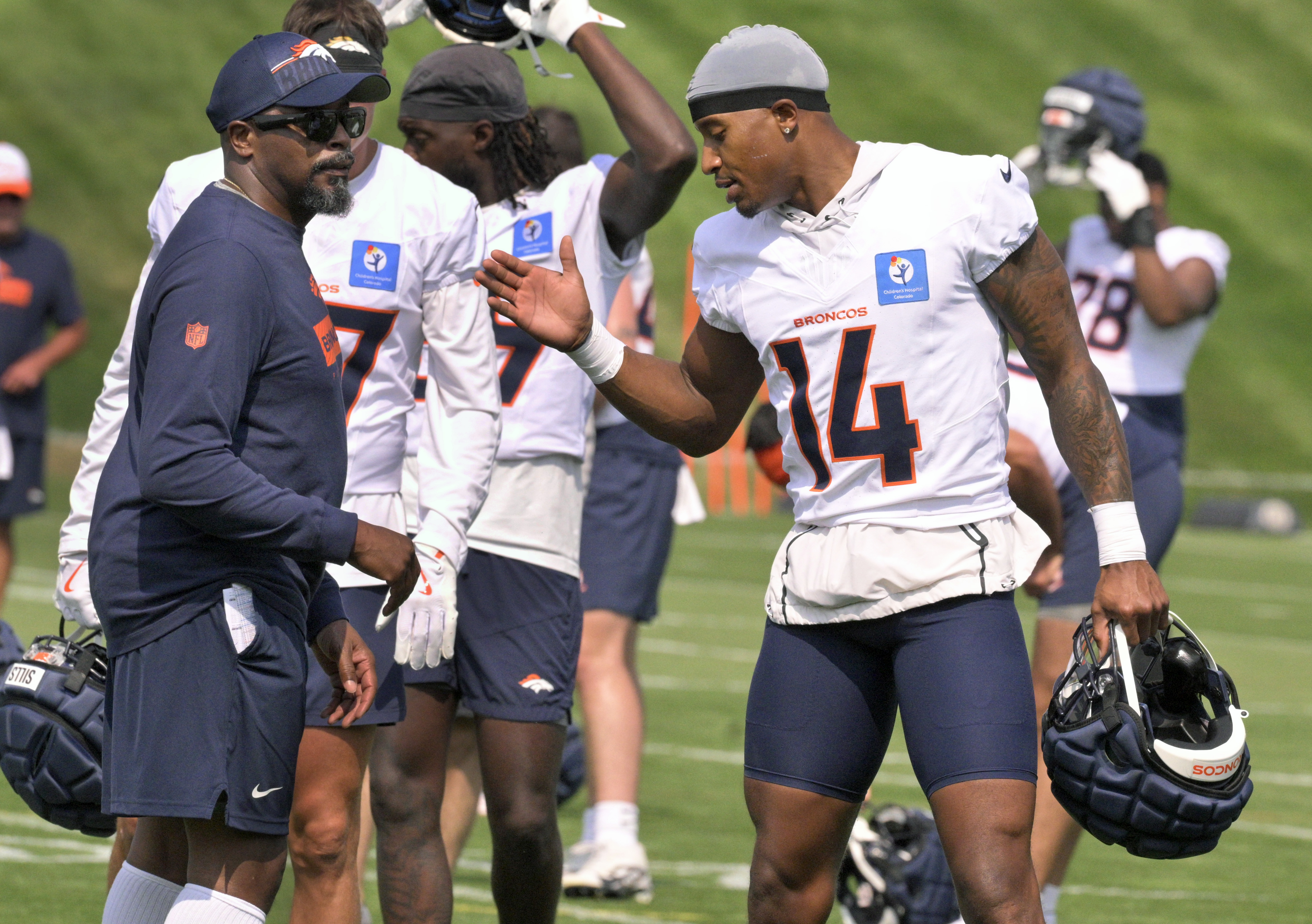 Broncos wide receiver Courtland Sutton chats with one of the coaches during practice at the Denver Broncos training center on Wednesday, July 24, 2024. (Jerilee Bennett The Gazette)