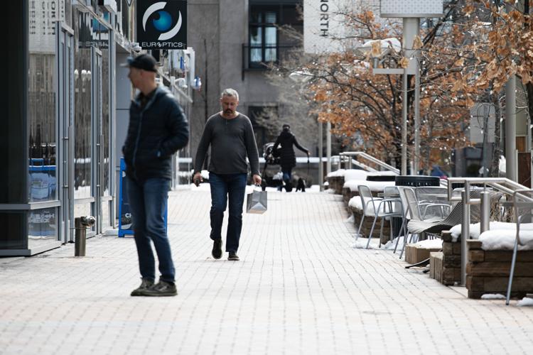 Shoppers pass through a section of Fillmore Street