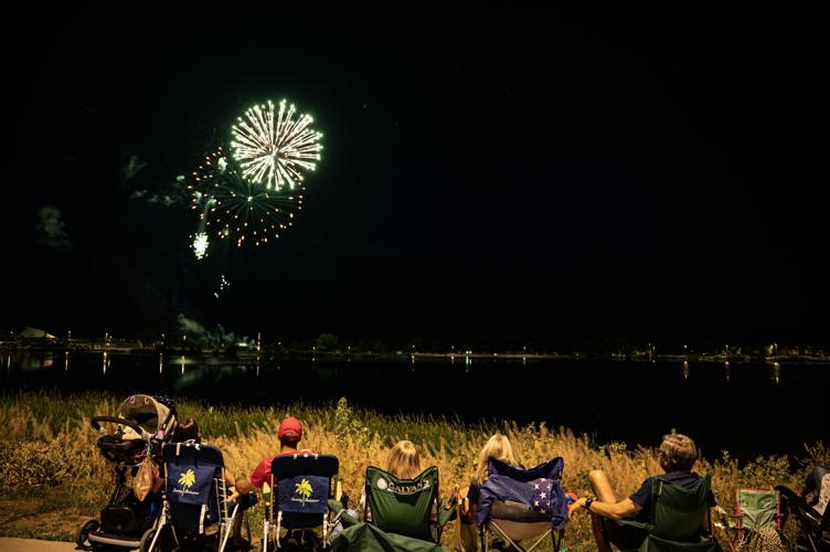 Spectators take in a fireworks show at Clement Park