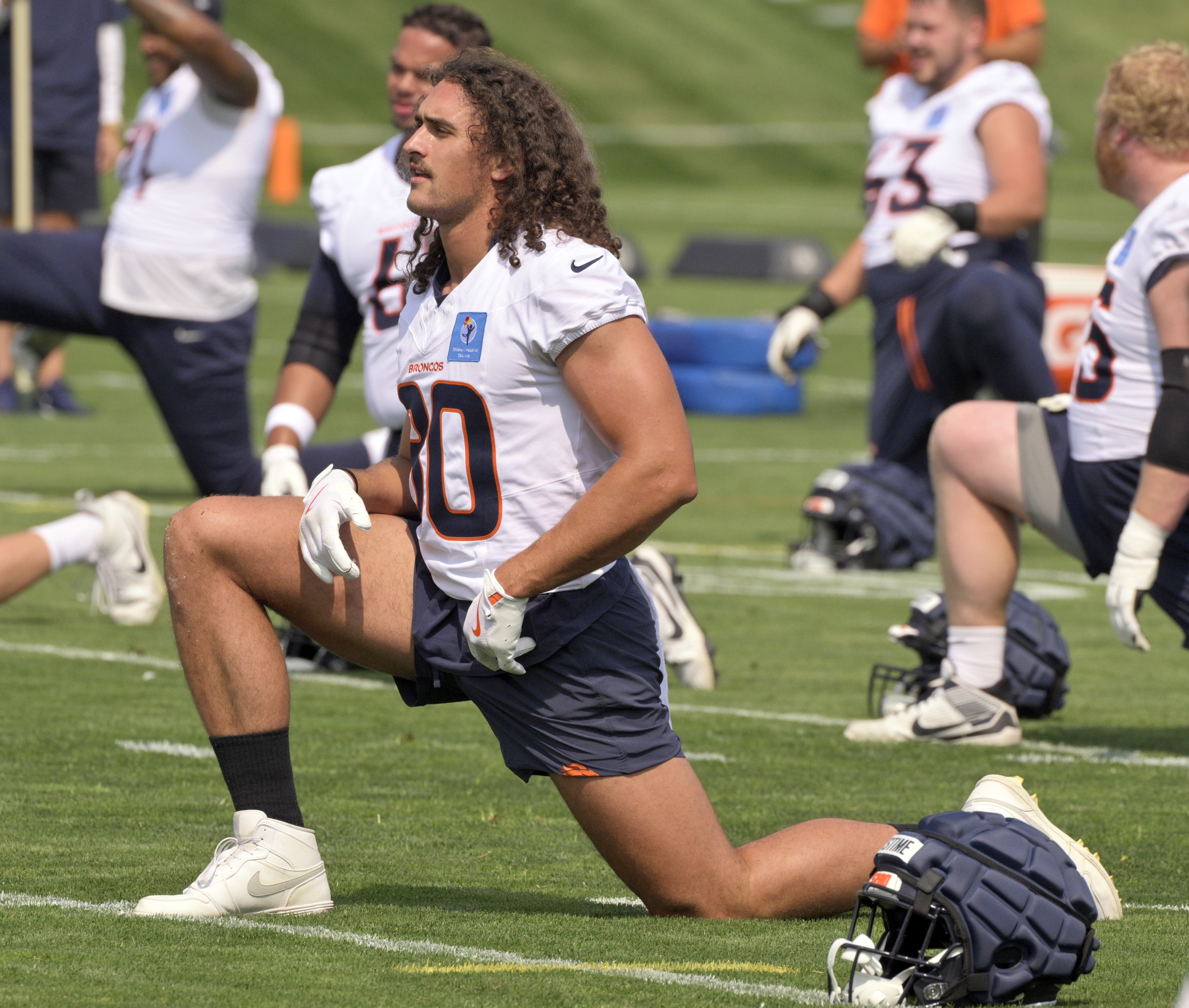 Broncos tight end Greg Dulcich stretches during practice at the Denver Broncos training center on Wednesday, July 24, 2024. (Jerilee Bennett The Gazette)