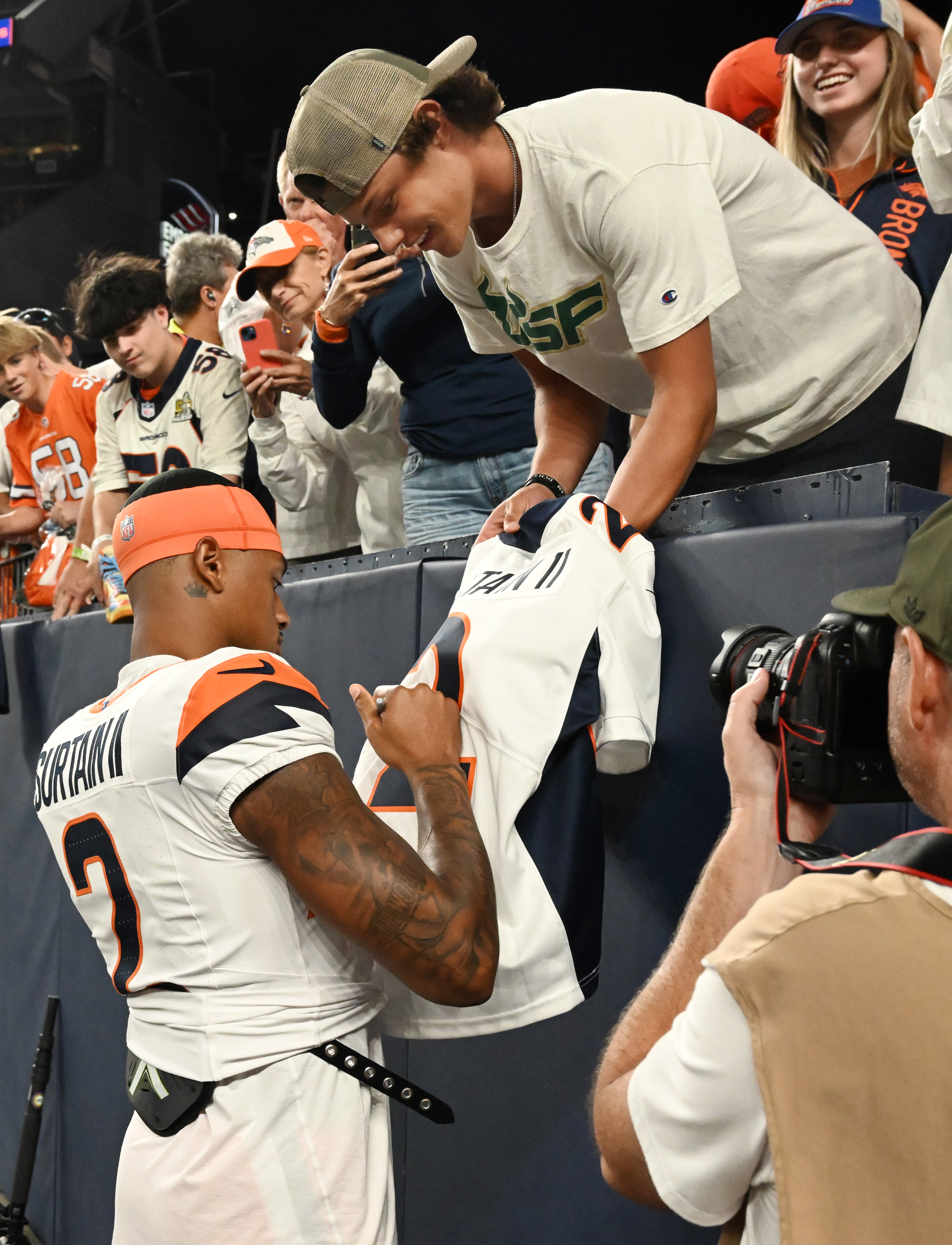 Broncos quarterback cornerback Pat Surtain II signs a jersey for a fan after a preseason game against the Packers on Sunday, Aug. 18, 2024. The Broncos won the game 28-2. (Jerilee Bennett The Gazette)