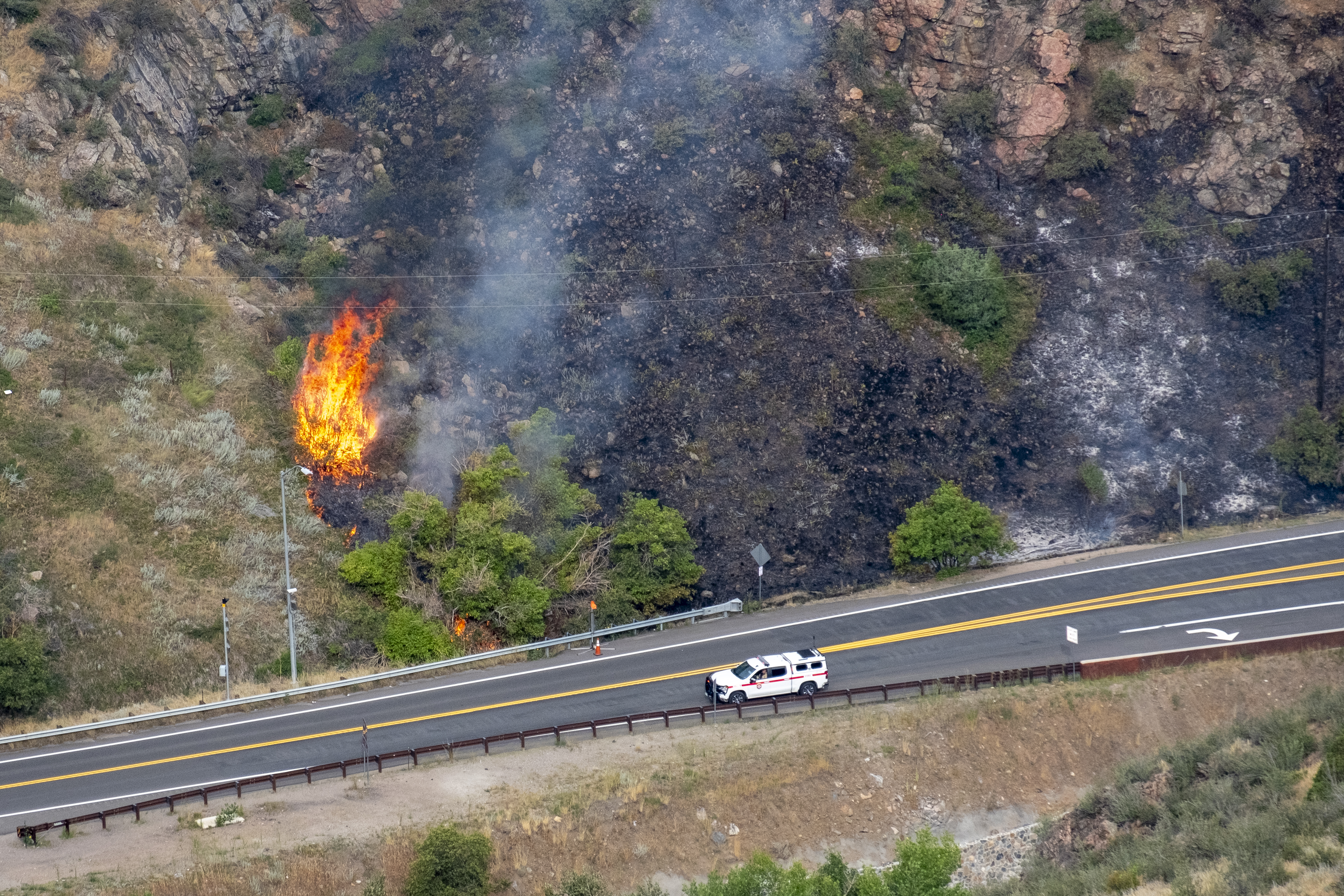 FILE PHOTO: A wildfire burns shrub brush near U.S. Hwy 6 around Tunnel 1 in Clear Creek Canyon Wednesday, Aug. 21, 2024. The wildfire started Tuesday, Aug. 20 from a lightning strike during an afternoon thunderstorm. A JeffCo Sheriff's spokesperson said the blaze is 100% contained as of Thursday afternoon. (JonathanIngrahamDigital Strategistjonathan.ingraham@denvergazette.comhttps://denvergazette.com/content/tncms/avatars/c/dd/7f0/cdd7f086-b693-11ec-b373-bba598953eb6.fc0f5608a6f1144f64f080f771bd904d.png)