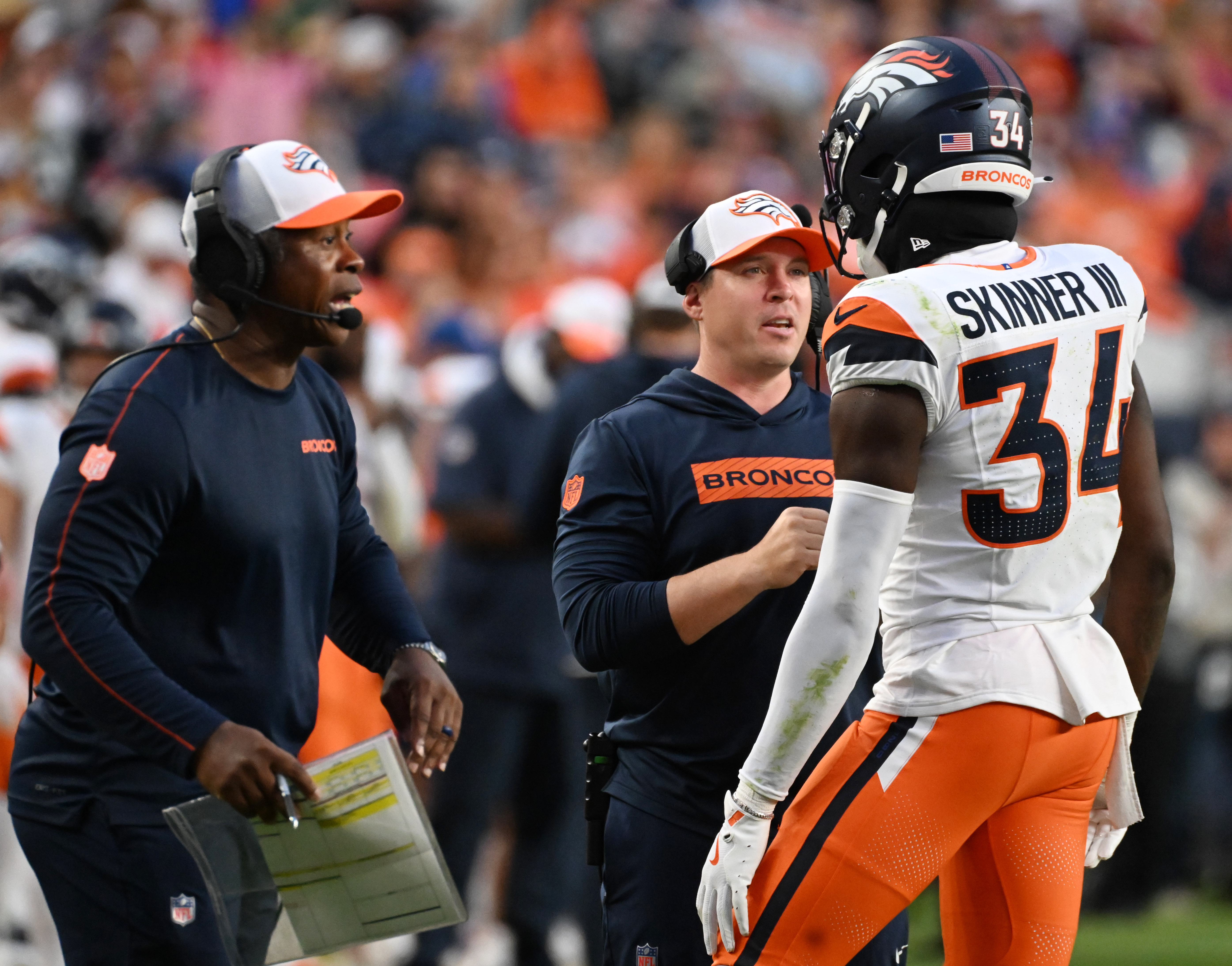 Broncos defensive coordinator Vance Joseph chats with Broncos safety JL Skinner during the second quarter of a preseason game against the Packers on Sunday, Aug. 18, 2024. (Jerilee Bennett The Gazette)