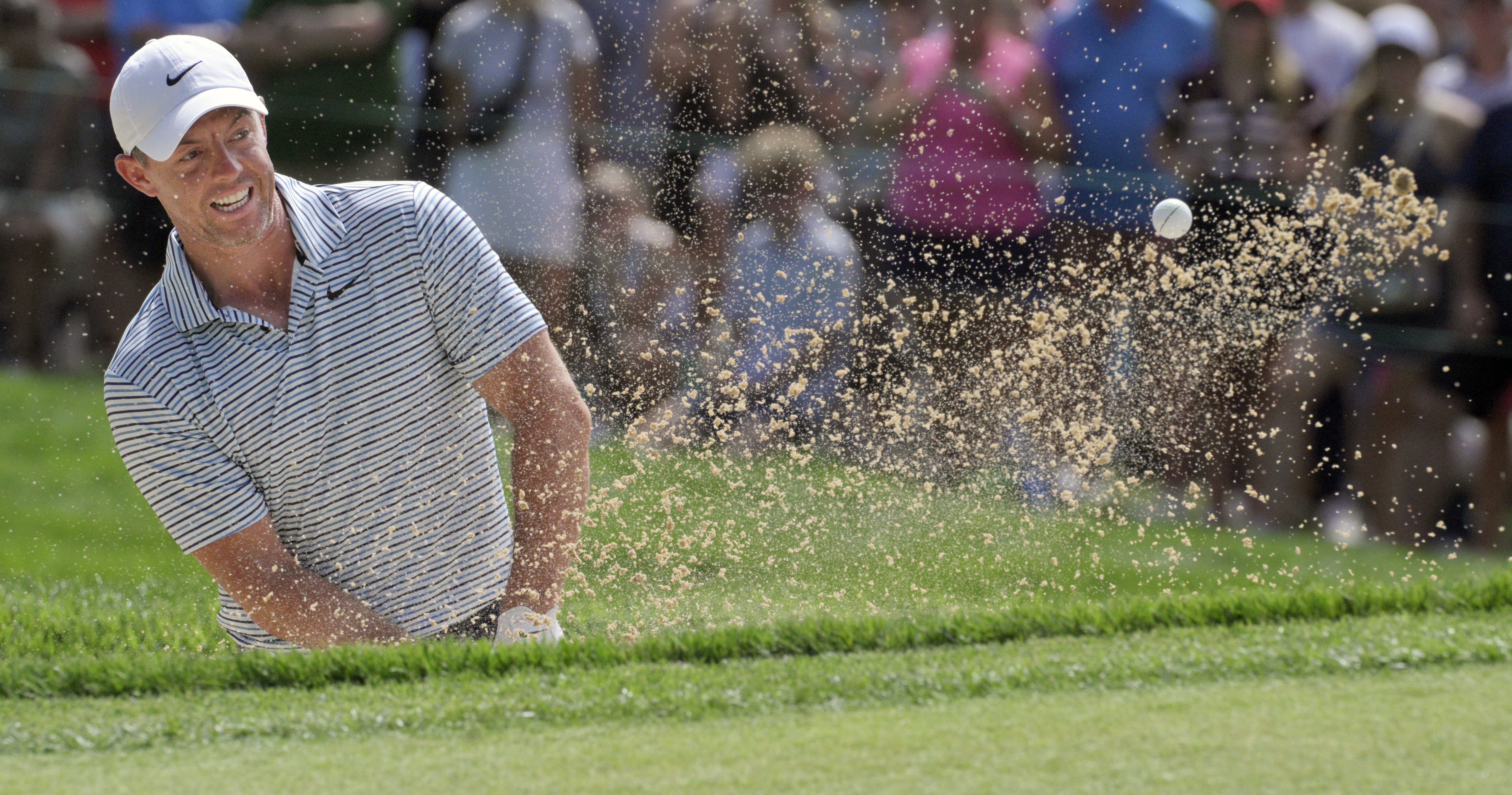 Rory McElroy hits out of a sand trap on the 18th hole at the BMW Championship on Sunday, August 25, 2024. They just happened to be paired together as being in 3rd and 4th place at the beginning of the day.