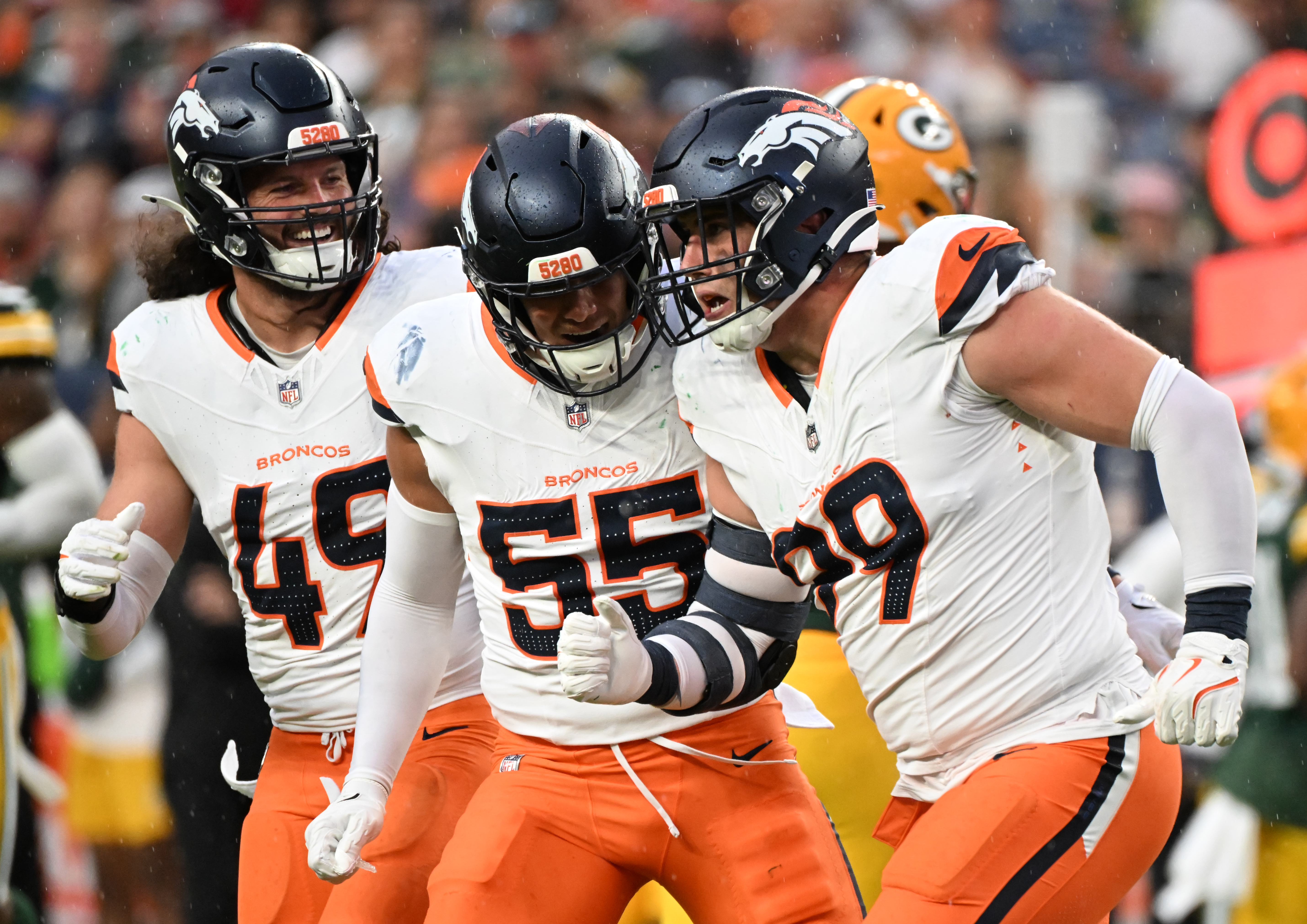 Broncos defensive end Zach Allen (right) is congratulated by Denver Broncos linebacker Alex Singleton (49) and Denver Broncos linebacker Cody Barton (55) during a preseason game against the Packers on Sunday, Aug. 18, 2024. The Broncos won the game 27-2. (Jerilee Bennett, The Gazette)