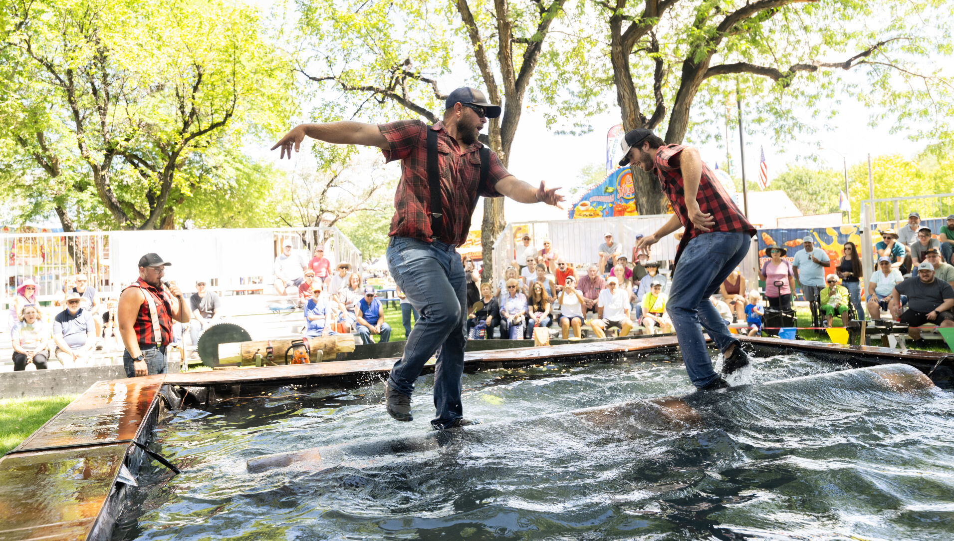 Lyle LeCaptain, left, and Jasper Mayer compete in the log roll during the Paul Bunyan Lumberjack Show Friday, Aug. 23, 2024, on the first day of the Colorado State Fair in Pueblo. The fair runs through Labor Day, Sept. 2, 2024. (The Gazette, Christian Murdock) (Christian Murdock, The Gazette)