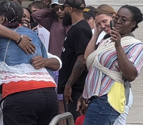 Stephan Long hugs his family as a free man for the first time in 14 months minutes after he walked out of the Denver jail after his ankle monitor was removed. His record is now expunged. (Carol McKinley)