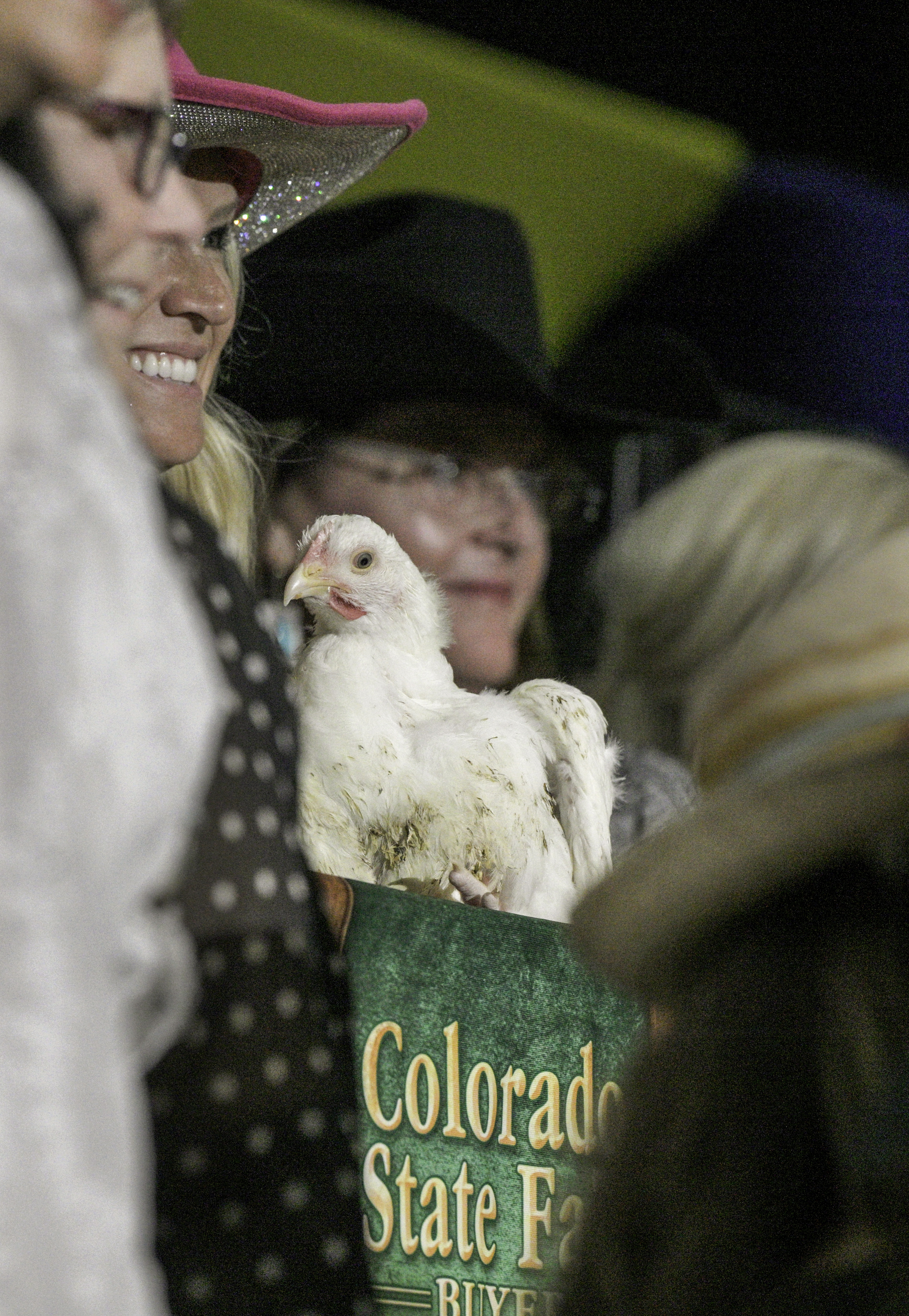 After pooling their money together, the “Fair Ladies” bid on the chickens at the Junior Livestock Auction at the Colorado State Fair on Tuesday, Aug. 27, 2024. (Jerilee Bennett The Gazette)