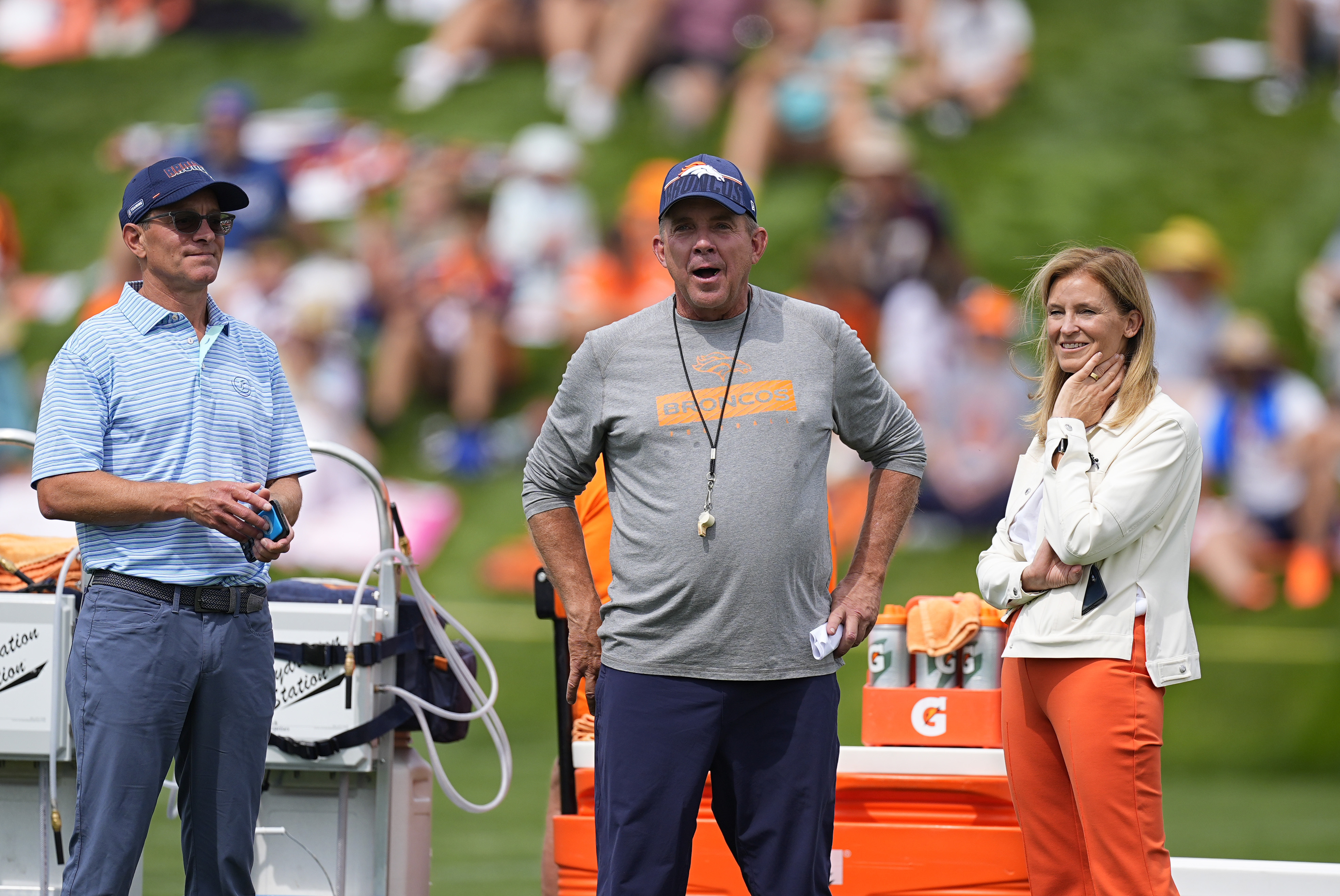 Denver Broncos head coach Sean Payton chats with team owners Greg Penner, left, and Carrie Walton Penner during an NFL football training camp Friday, July 26, 2024, at the team's headquarters in Centennial, Colo.(AP Photo/David Zalubowski) (David Zalubowski)