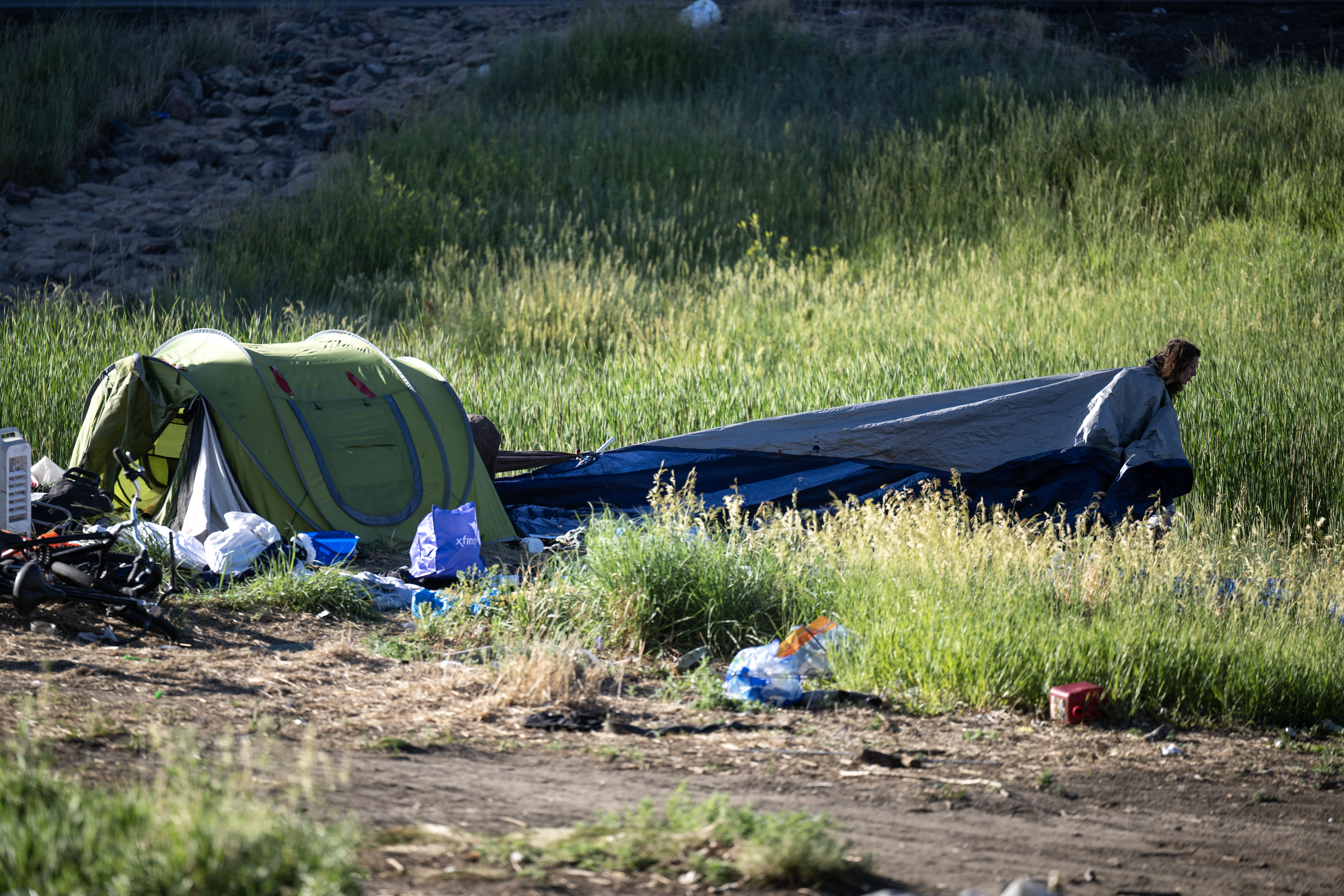 Casey Horn drags a tarp away from her encampment near 38th and Fox in Denver as she and her friends try to pack as much as they can before being forced to move in a police sweep of the encampment on Thursday, June 13, 2024. (StephenSwoffordPhotographerstephen.swofford@gazette.comhttps://secure.gravatar.com/avatar/1ddcaf11c5d70eaa58546ddc4e038687?d=mm&r=g)