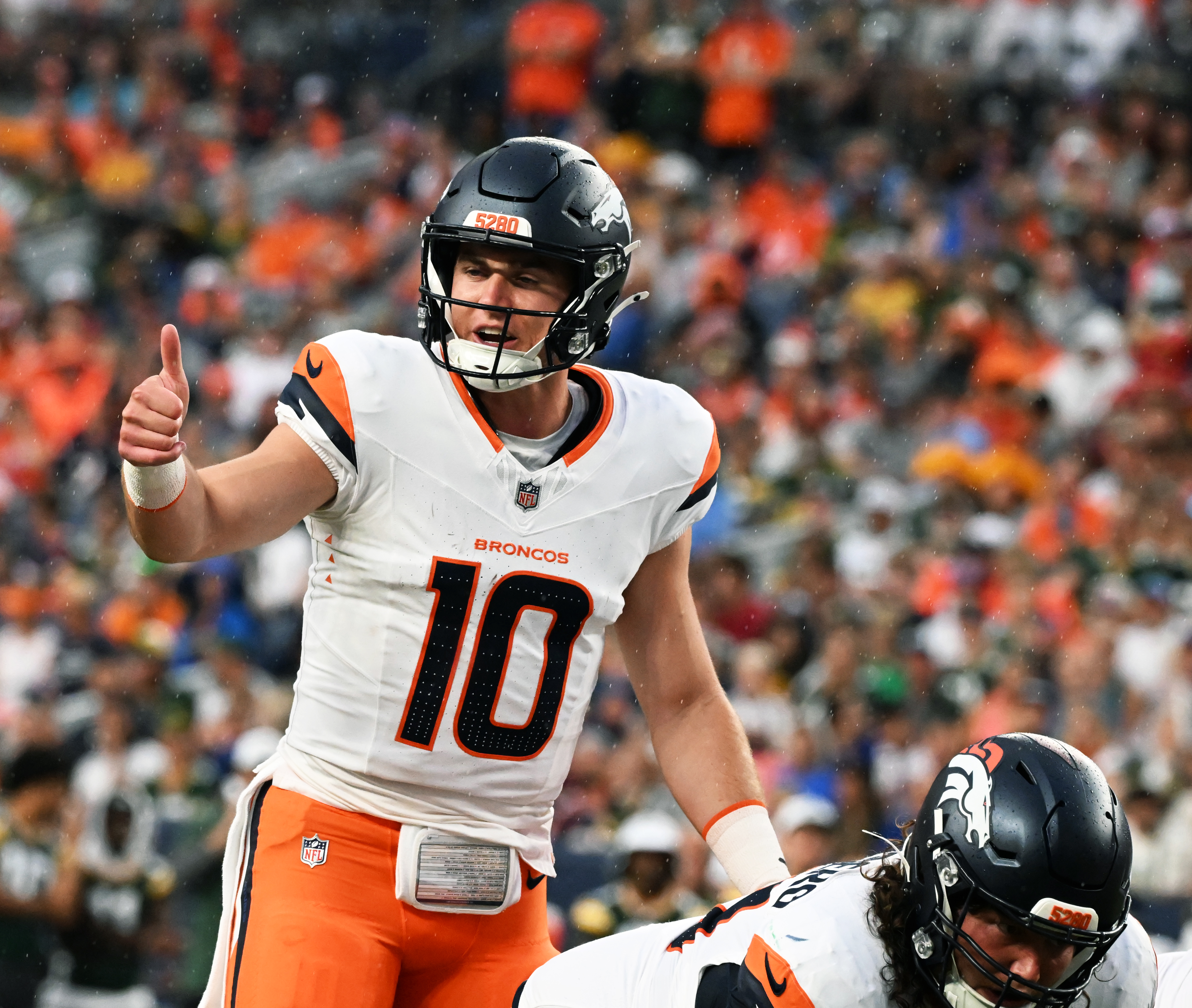 Broncos quarterback Bo Nix gives the thumbs up before throwing a touchdown during the second quarter of a preseason game against the Packers on Sunday, Aug. 18, 2024. (Jerilee Bennett The Gazette)