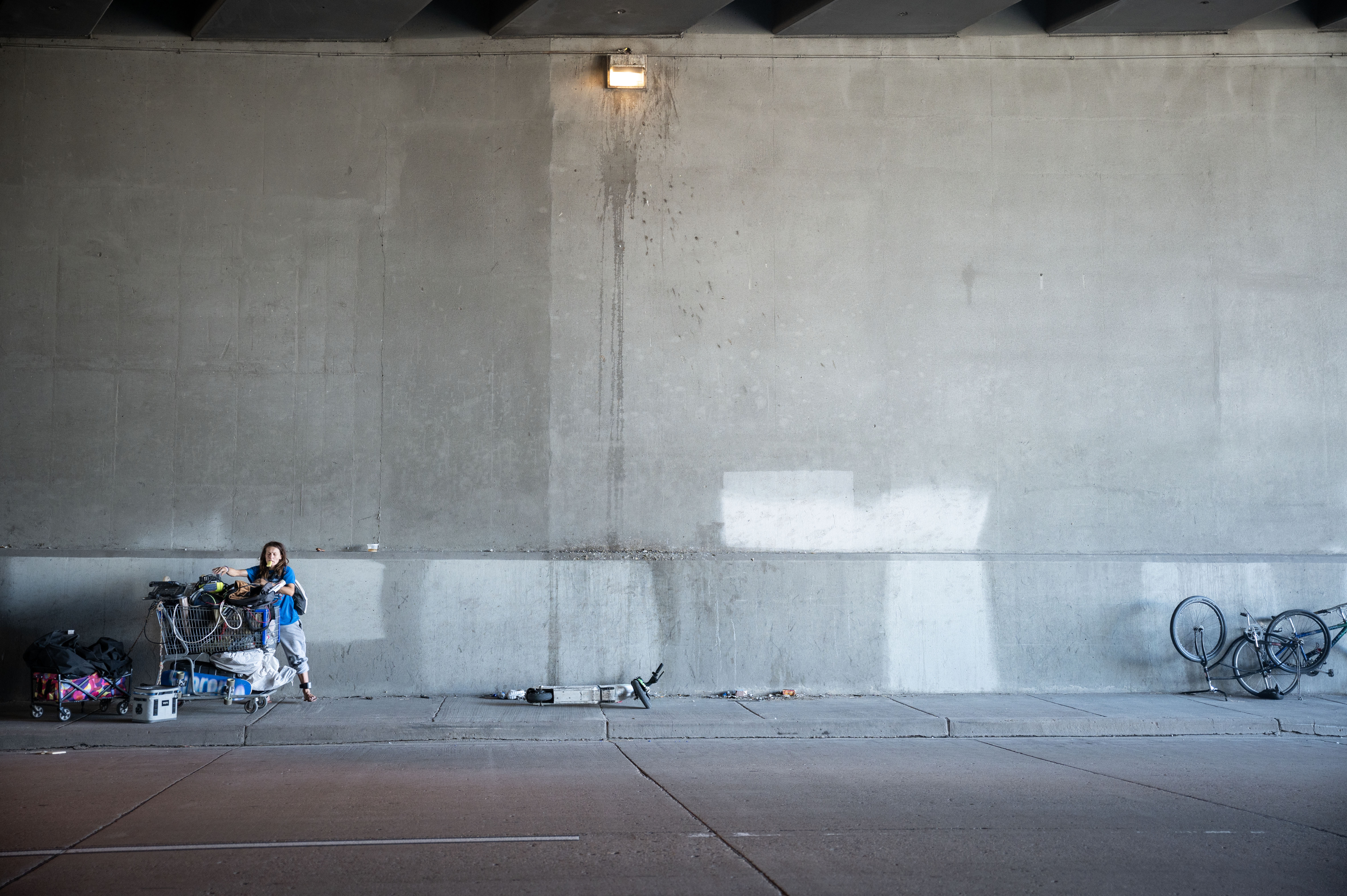 Casey Horn moves a shopping cart with her belongings from beneath an underpass near 38th and Fox in Denver on Thursday, June 13, 2024. Horn and her friends had relocated to the underpass after a sweep of their camp nearby. A few minutes later, they were told that the underpass would be included in the sweep and they had 45 minutes to relocate anew or lose their possessions. (StephenSwoffordPhotographerstephen.swofford@gazette.comhttps://secure.gravatar.com/avatar/1ddcaf11c5d70eaa58546ddc4e038687?d=mm&r=g)