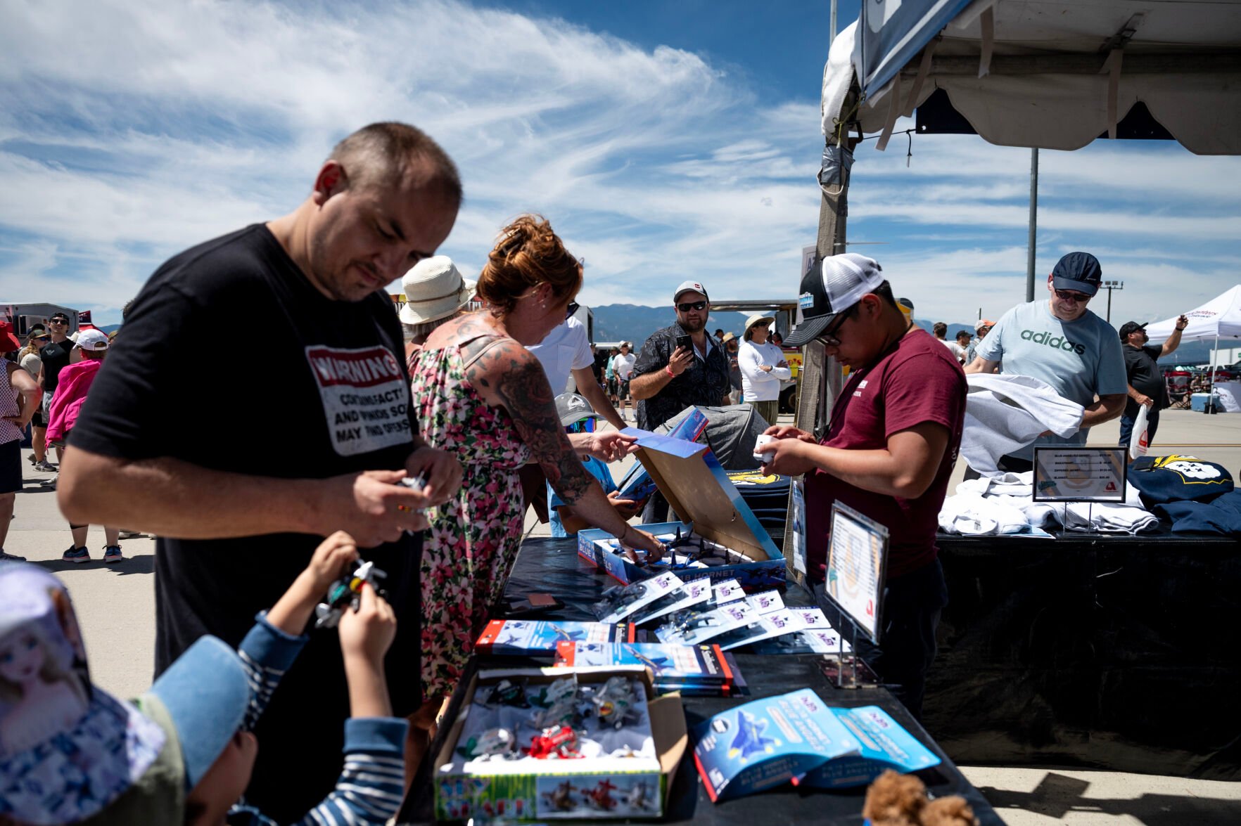 People shop for Blue Angels souvenirs at the Pikes Peak Regional Airshow at the Colorado Springs Airport on Saturday, Aug. 17, 2024. (Parker Seibold, The Gazette) (Parker Seibold The Gazette)