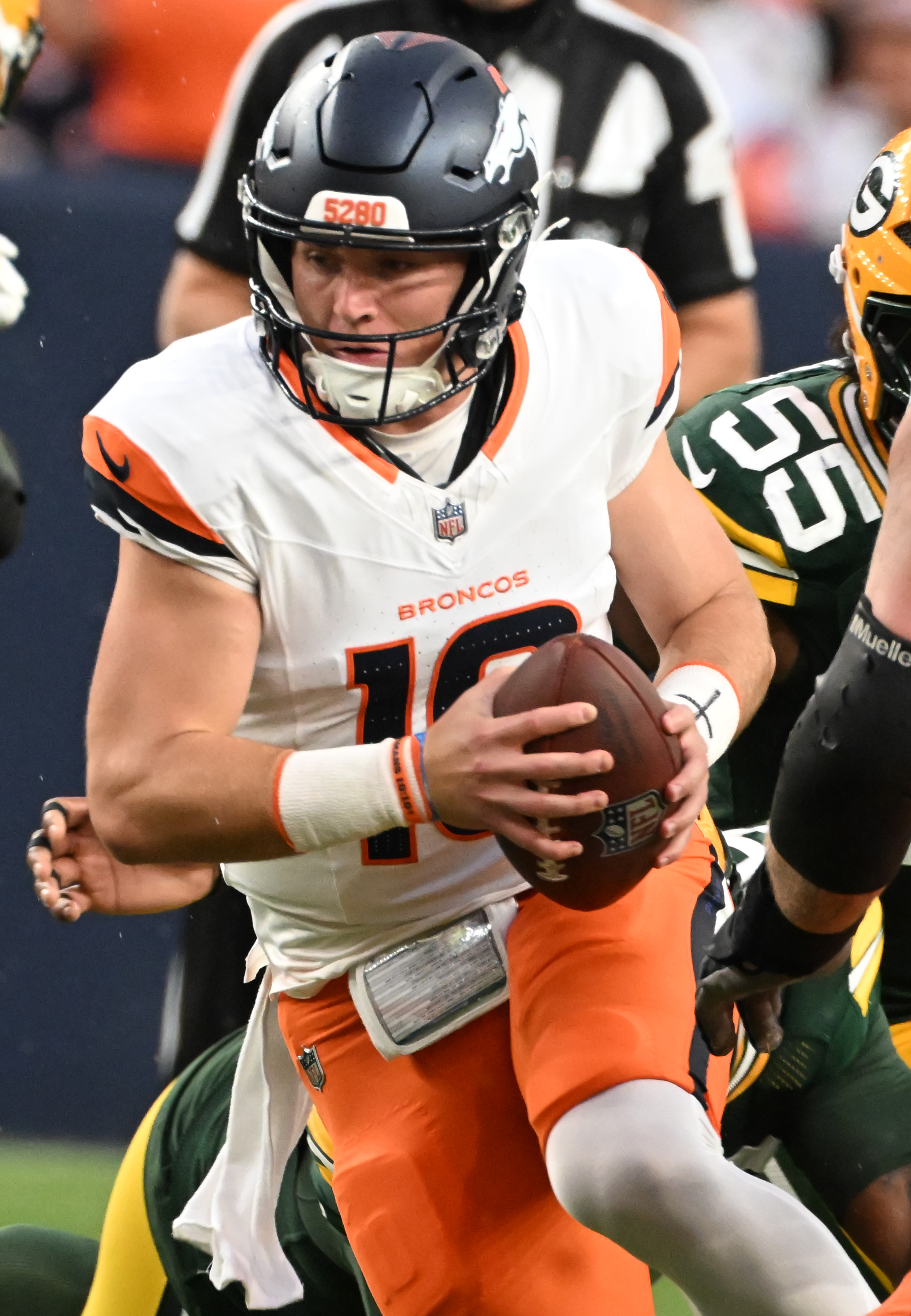 Broncos quarterback Bo Nix scrambles with the ball during the first quarter of a preseason game against the Packers on Sunday, Aug. 18, 2024. (Jerilee Bennett The Gazette)