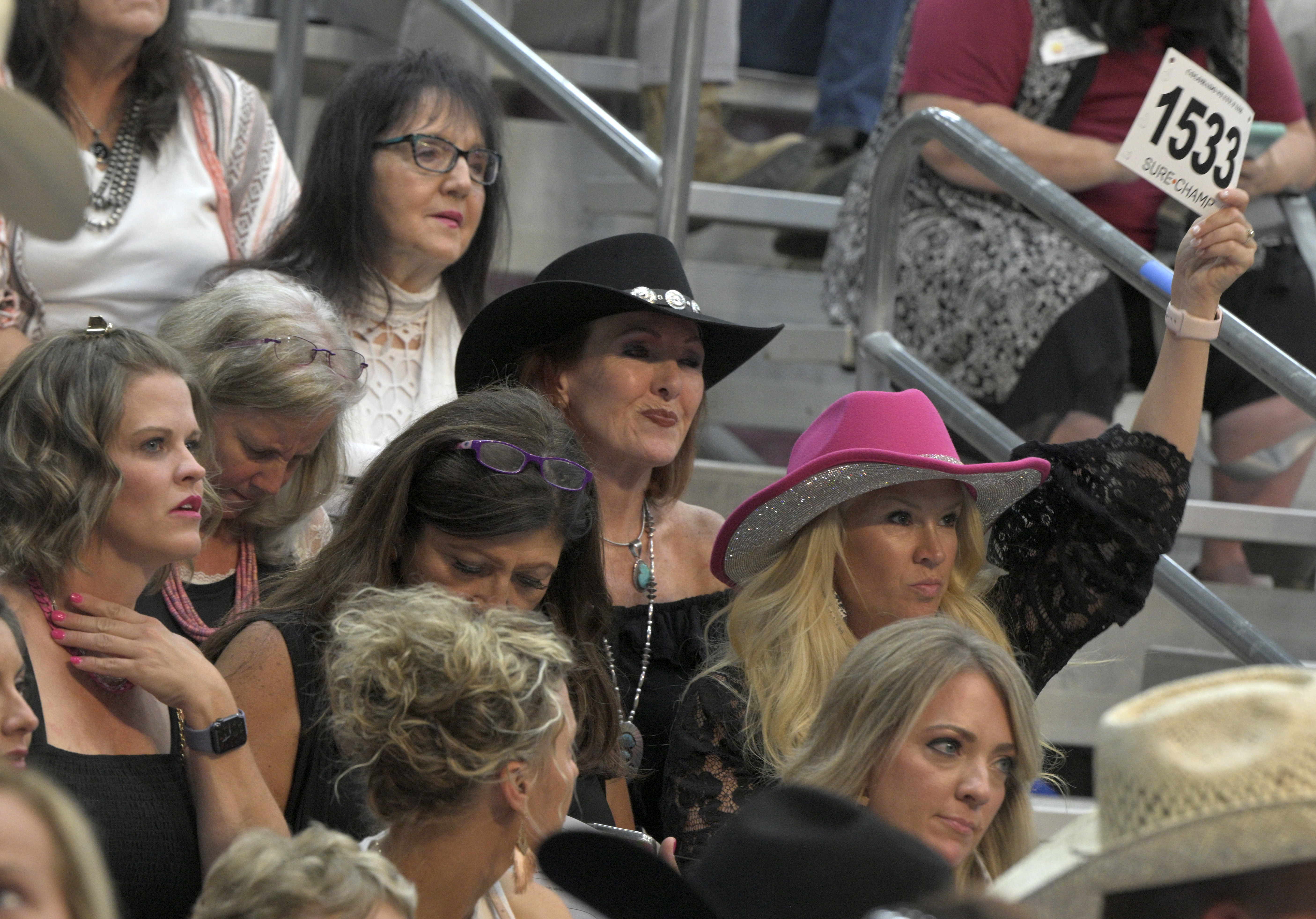 After pooling their money together, the “Fair Ladies” bid on the chickens at the Junior Livestock Auction at the Colorado State Fair on Tuesday, Aug. 27, 2024. (Jerilee Bennett The Gazette)