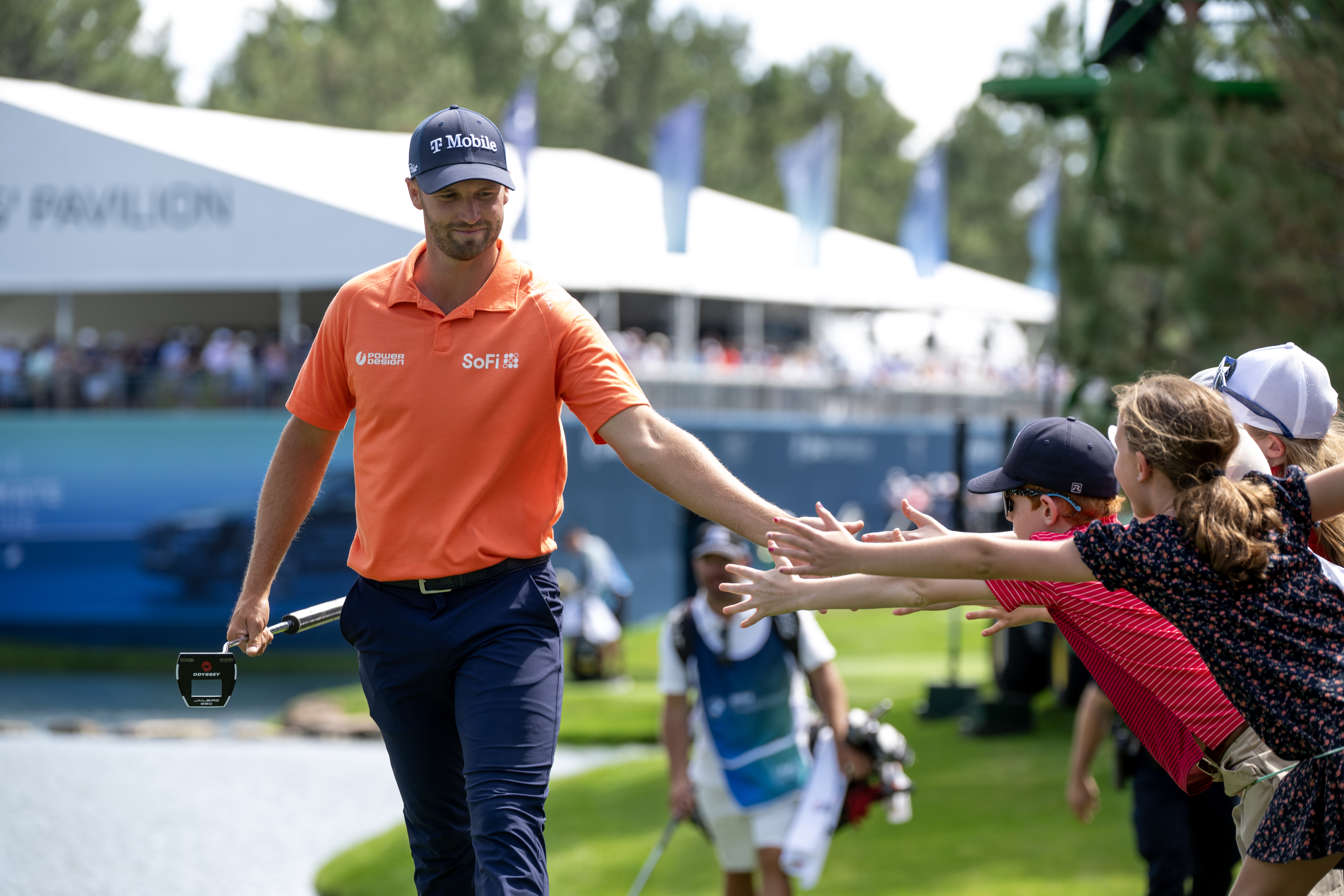 Wyndham Clark high-fives fans as he walks to the green on the sixteenth hole of the third round of the BMW Championship at Castle Pines Golf Club, Saturday, Aug. 24, 2024, in Castle Rock, Colo. (Parker Seibold, The Gazette) (Parker Seibold, The Gazette)