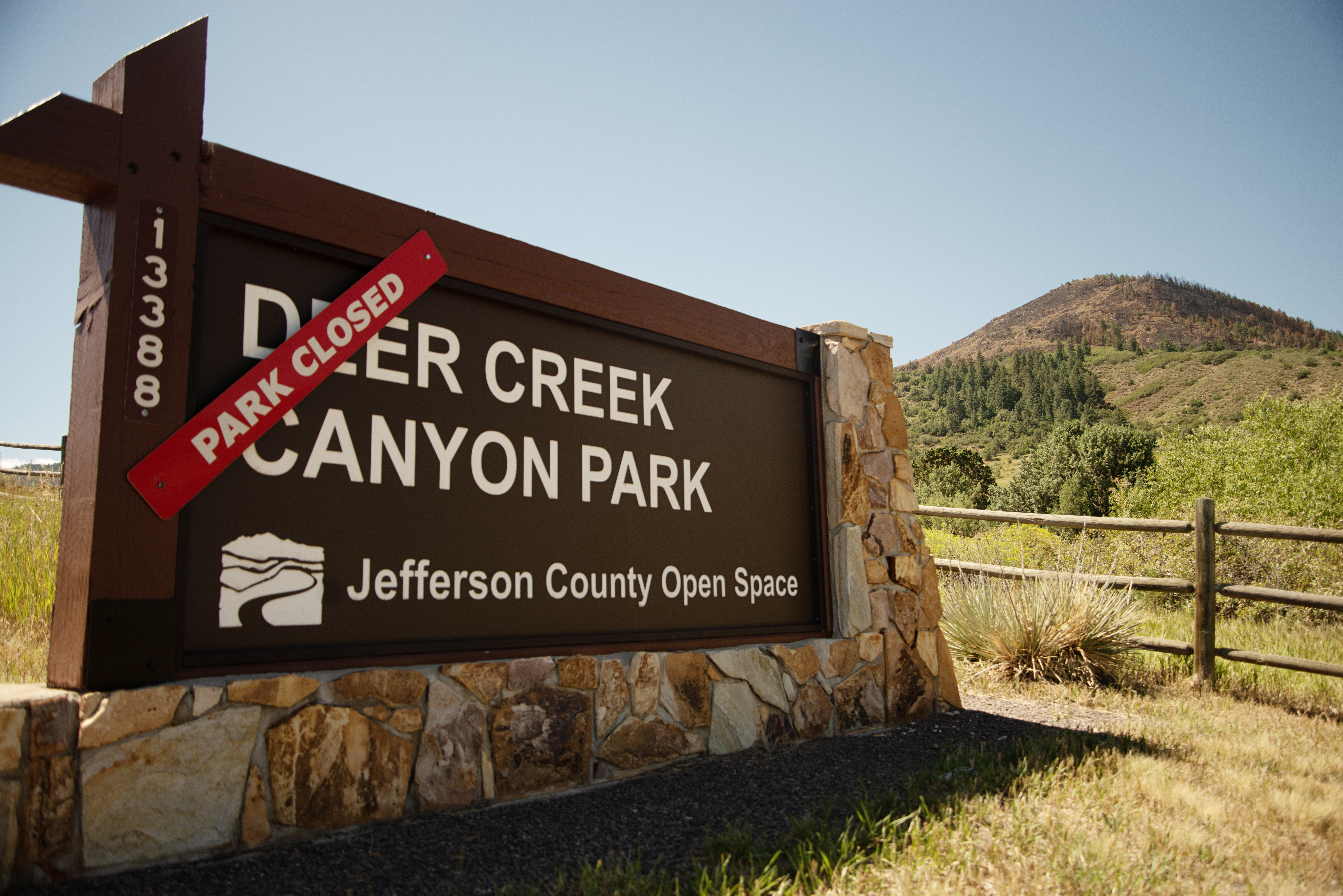 Deer Creek Canyon Park remains closed indefinitely while a burn scar from the Quarry Fire is visible on a hilltop in Littleton, Colo. on Friday, Aug. 16, 2024. (© Tom Hellauer)