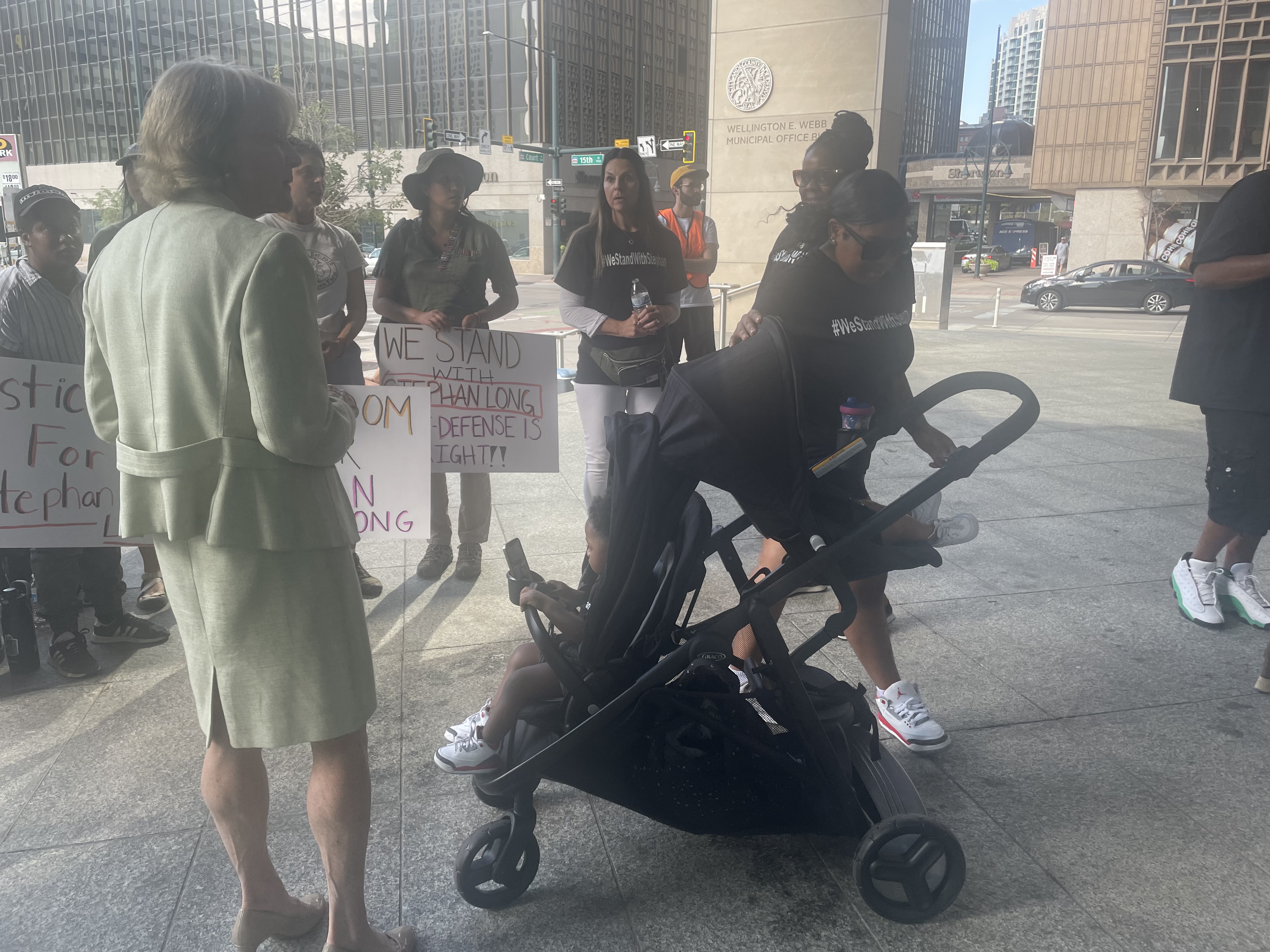 FILE PHOTO: Denver District Attorney Beth McCann meets with members of Stephan Long's family outside the Wellington E. Webb building on Thursday, Aug. 24, 2023. Supporters gathered to demand prosecutors drop first-degree murder charges against Long, who is accused of killing two brothers in a road-rage incident in June on Interstate 25. McCann announced Wednesday she is working to dismiss the final murder charge against Long. (Julia Cardi/Denver Gazette)