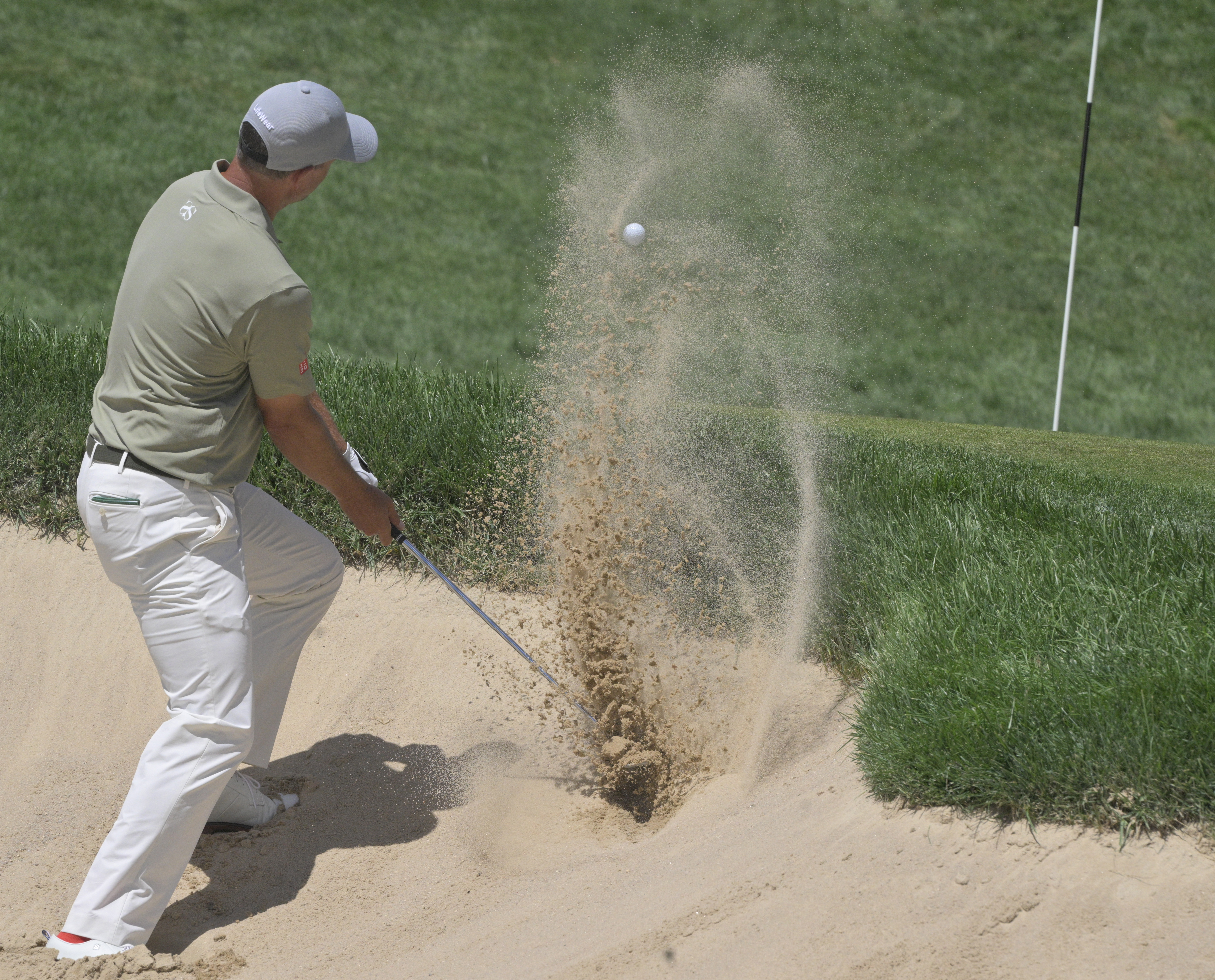 Adam Scott hits out of a sand trap on the 7th hole at the BMW Championship on Sunday, August 25, 2024. They just happened to be paired together as being in 3rd and 4th place at the beginning of the day.