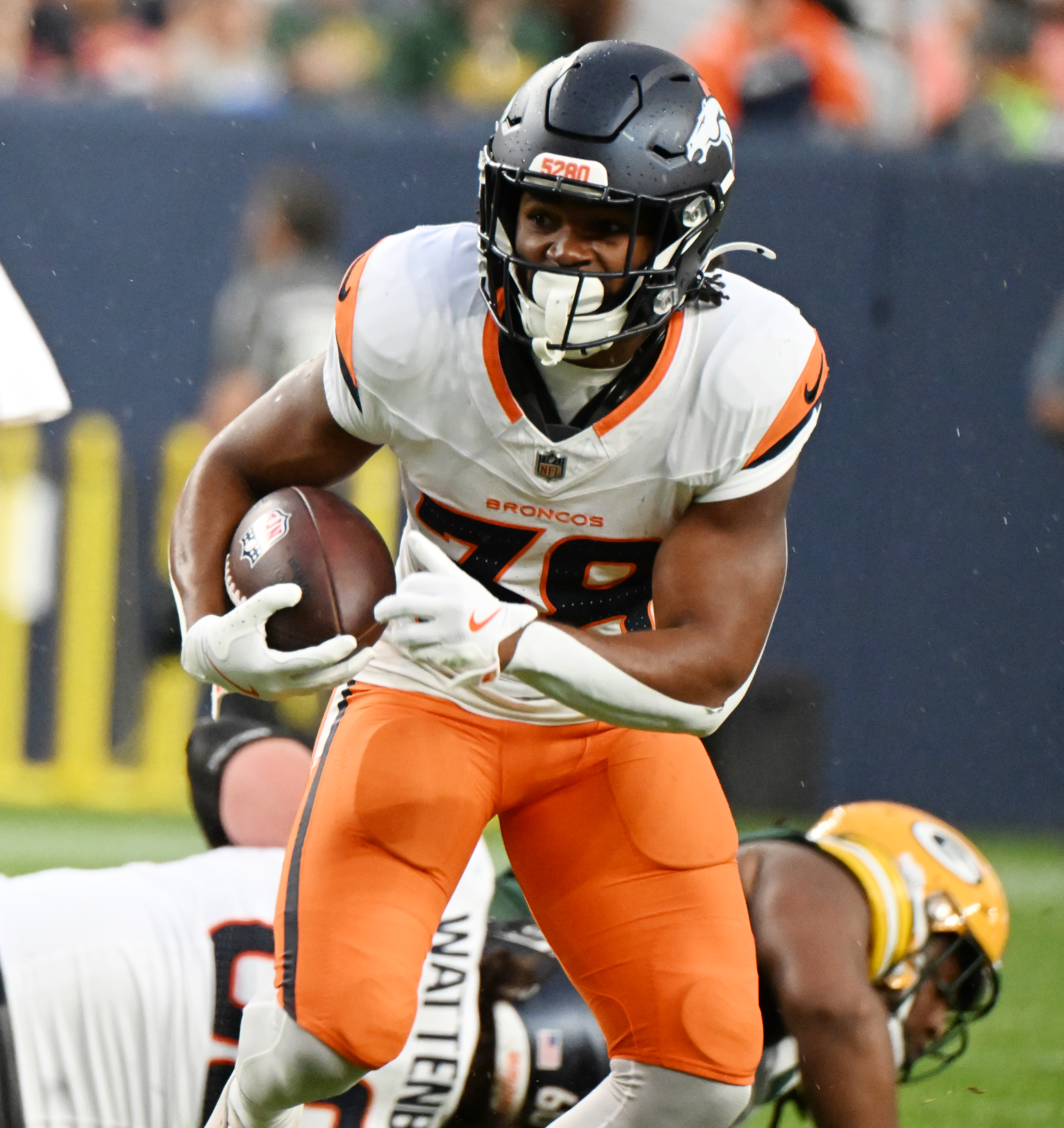 Broncos running back Jaleel McLaughlin runs with the ball during the first quarter of a preseason game against the Packers on Sunday, Aug. 18, 2024. (Jerilee Bennett The Gazette)