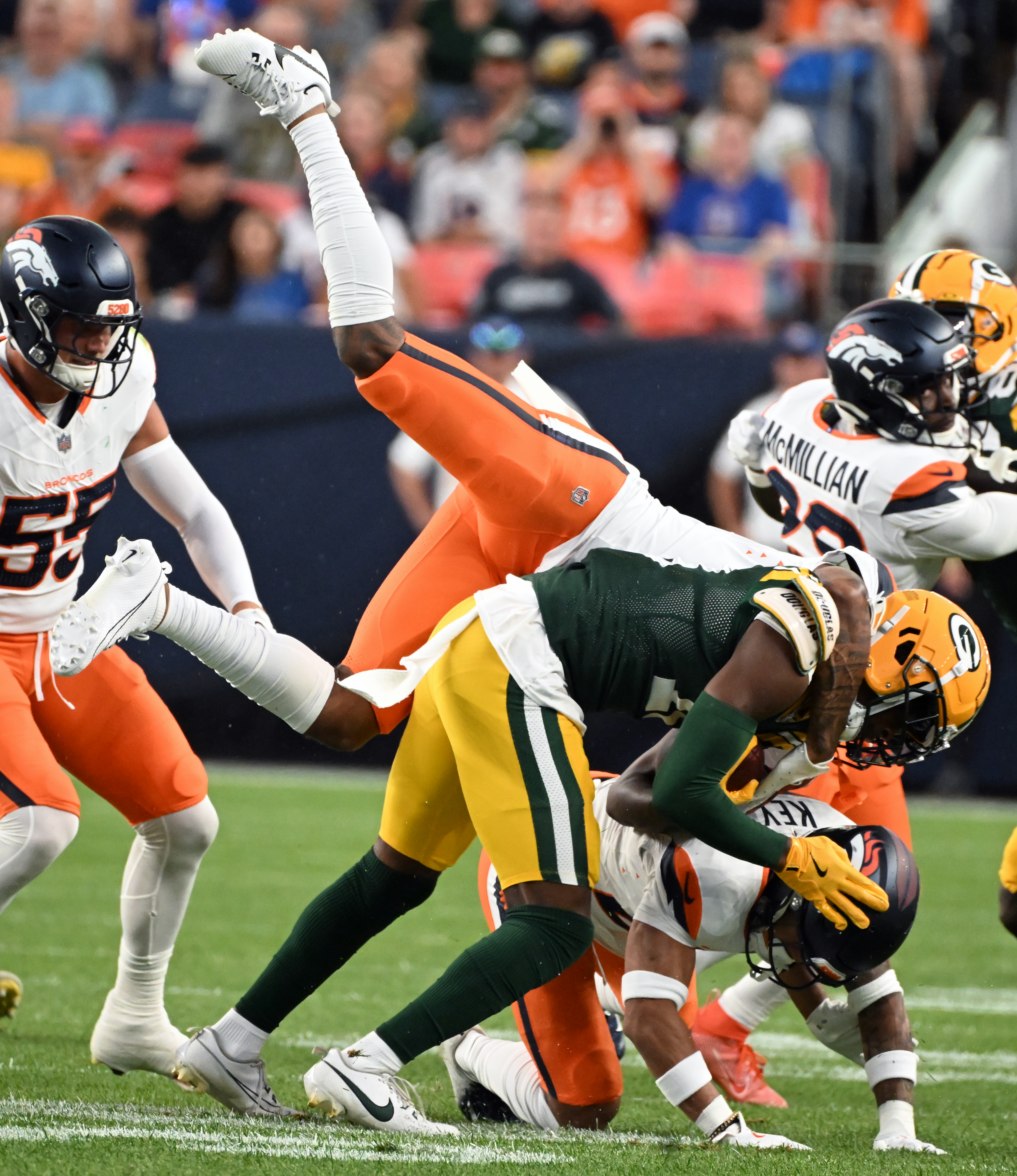 Denver Broncos safety P.J. Locke (6) tackles Green Bay Packers wide receiver Malik Heath (18) during a preseason game against the Packers on Sunday, Aug. 18, 2024. The Broncos won the game 27-2. (Jerilee Bennett, The Gazette)