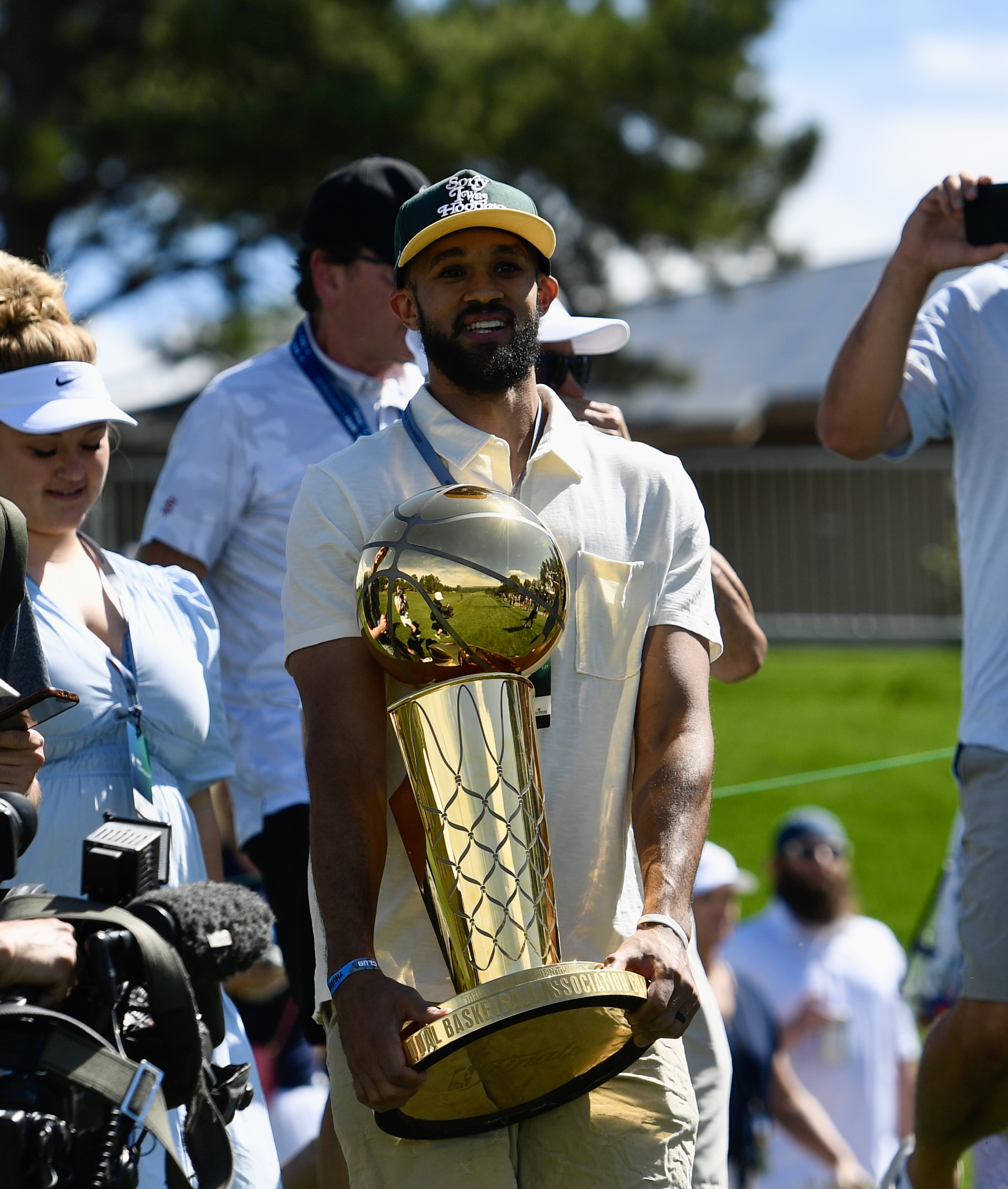 Celtics star Derrick White poses with the Larry O'Brien Championship Trophy at Castle Pines Golf Club during the first round of the BMW Championship on Thursday, Aug. 22, 2024. (CarsonFieldcarson.field@gazette.comhttps://secure.gravatar.com/avatar/c524ef3d384945349bed78d70eb2d2cd?d=mm&r=g)