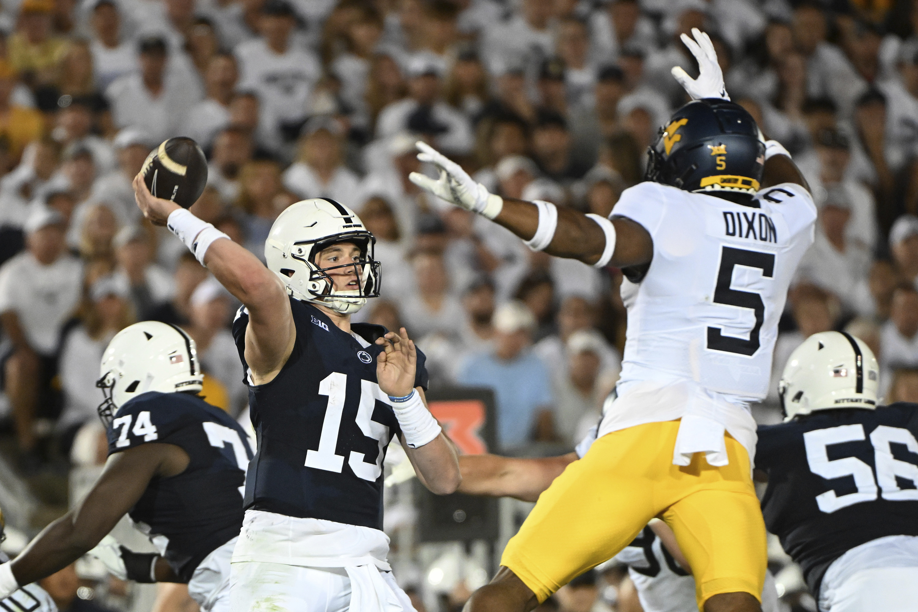 Penn State quarterback Drew Allar (15) passes while pressured by West Virginia linebacker Lance Dixon (5) during the second half of an NCAA college football game, Saturday, Sept. 2, 2023, in State College, Pa. (AP Photo/Barry Reeger) (Barry Reeger)
