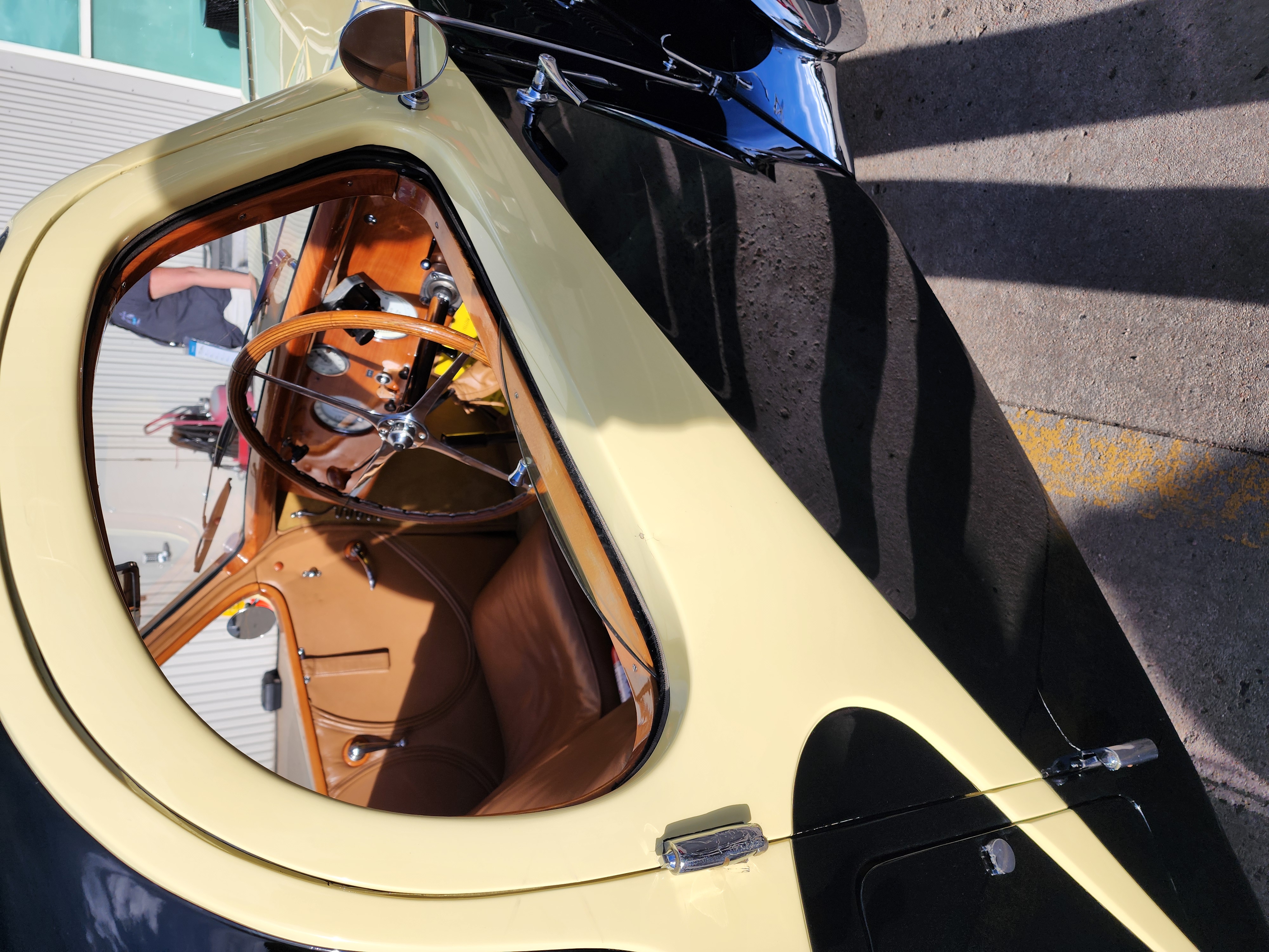 The meticulously restored interior of the 1936 Bugatti Type 57 Atalante Sunroof Coupe, showcasing its elegant woodwork and luxurious leather upholstery. (Marco Cummings)
