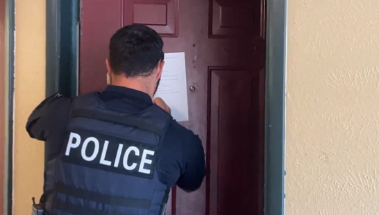 An Aurora police officer checks on an apartment unit in a video released by the city on Aug. 30. Aurora Interim Police Chief Heather Morris insists that gang members have not