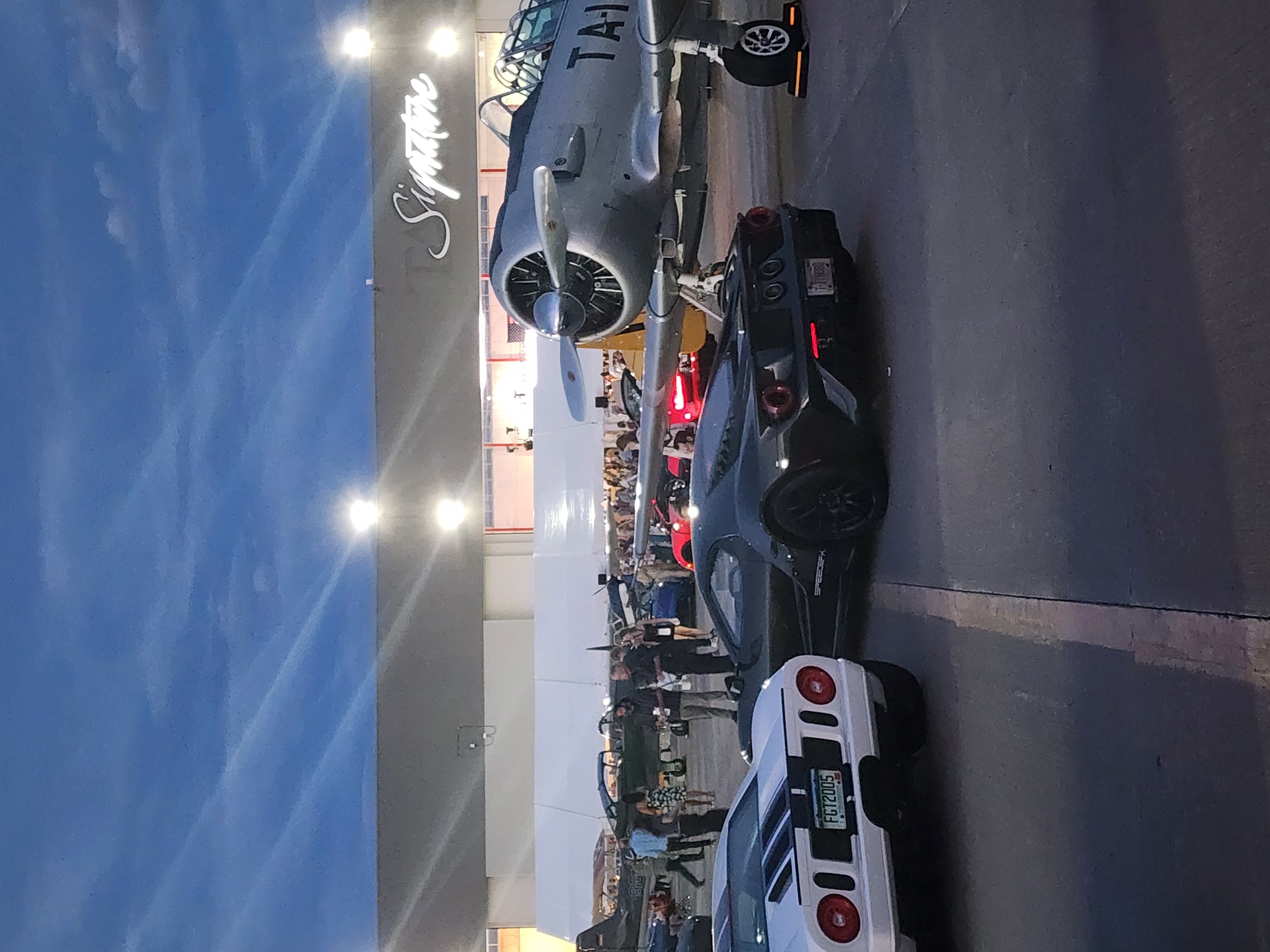 Two Ford GTs, a 2005 Ford GT (left) and a second generation Ford GT (right) parked next to a North American Aviation T-6 Texan aircraft (far right). (Marco Cummings)
