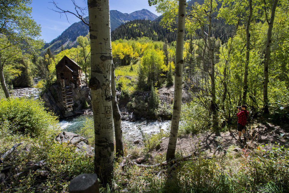 A photographer takes a picture of the Crystal Mill as the aspens begin to turn near Marble, Colo., Tuesday, Sept. 19, 2017. (The Gazette, Christian Murdock) (CHRISTIAN MURDOCK)