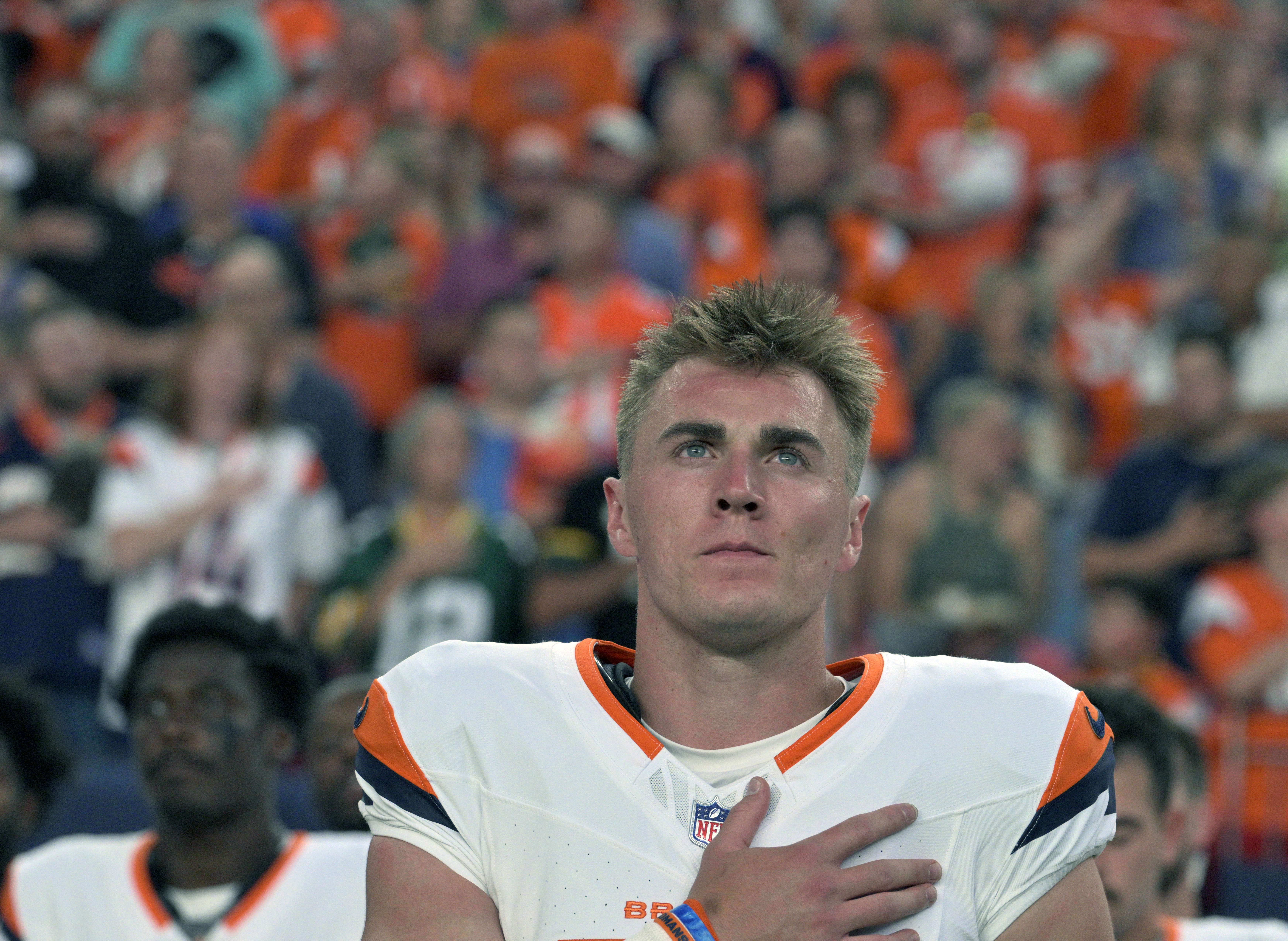 Broncos quarterback Bo Nix puts his hand over his heart for the national anthem before a preseason game against the Packers on Sunday, Aug. 18, 2024. The Broncos won the game 27-2. (Jerilee Bennett, The Gazette)
