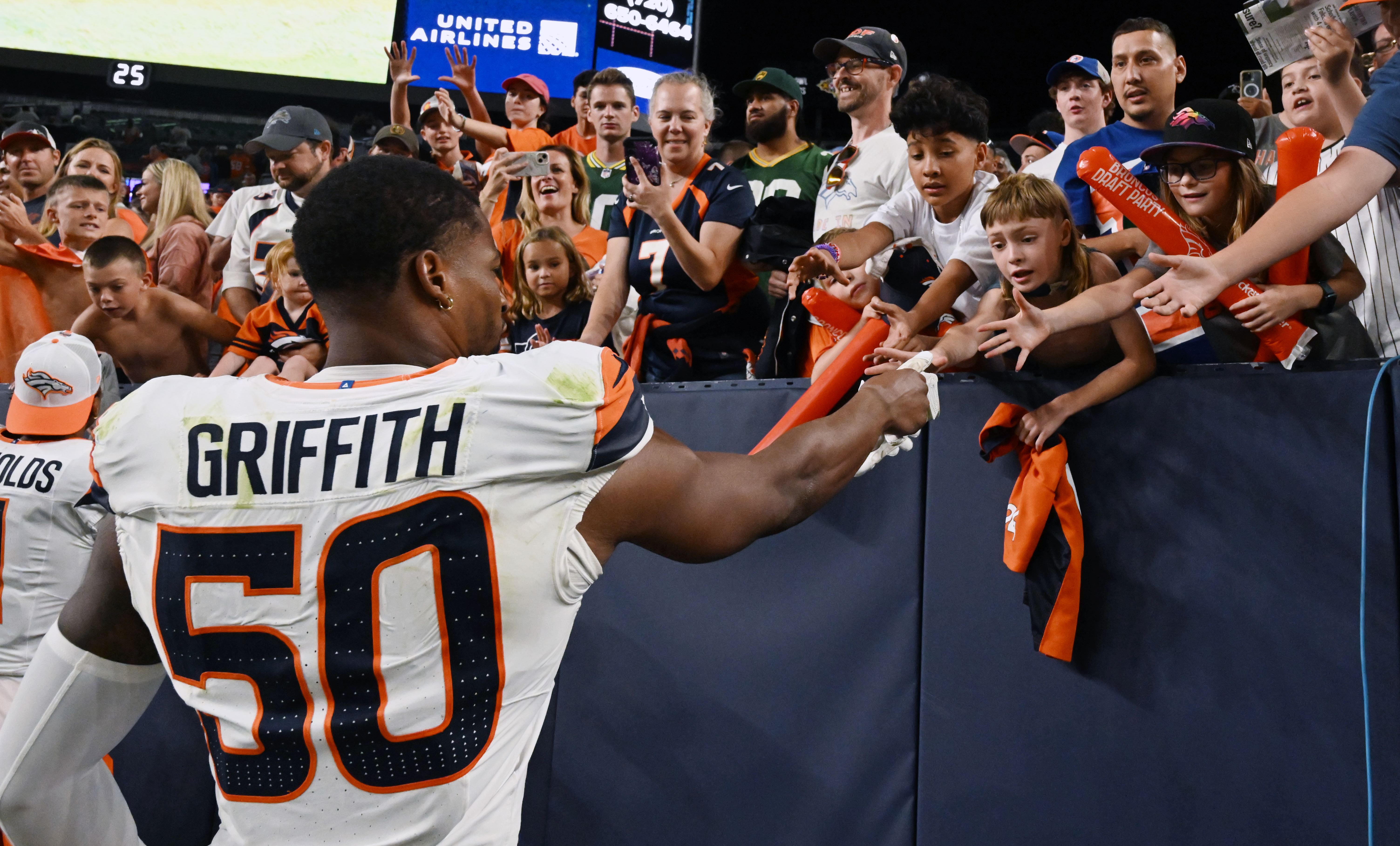Broncos linebacker Jonas Griffith hands off his gloves to some fans ater a preseason game against the Packers on Sunday, Aug. 18, 2024. The Broncos won the game 28-2. (Jerilee Bennett The Gazette)