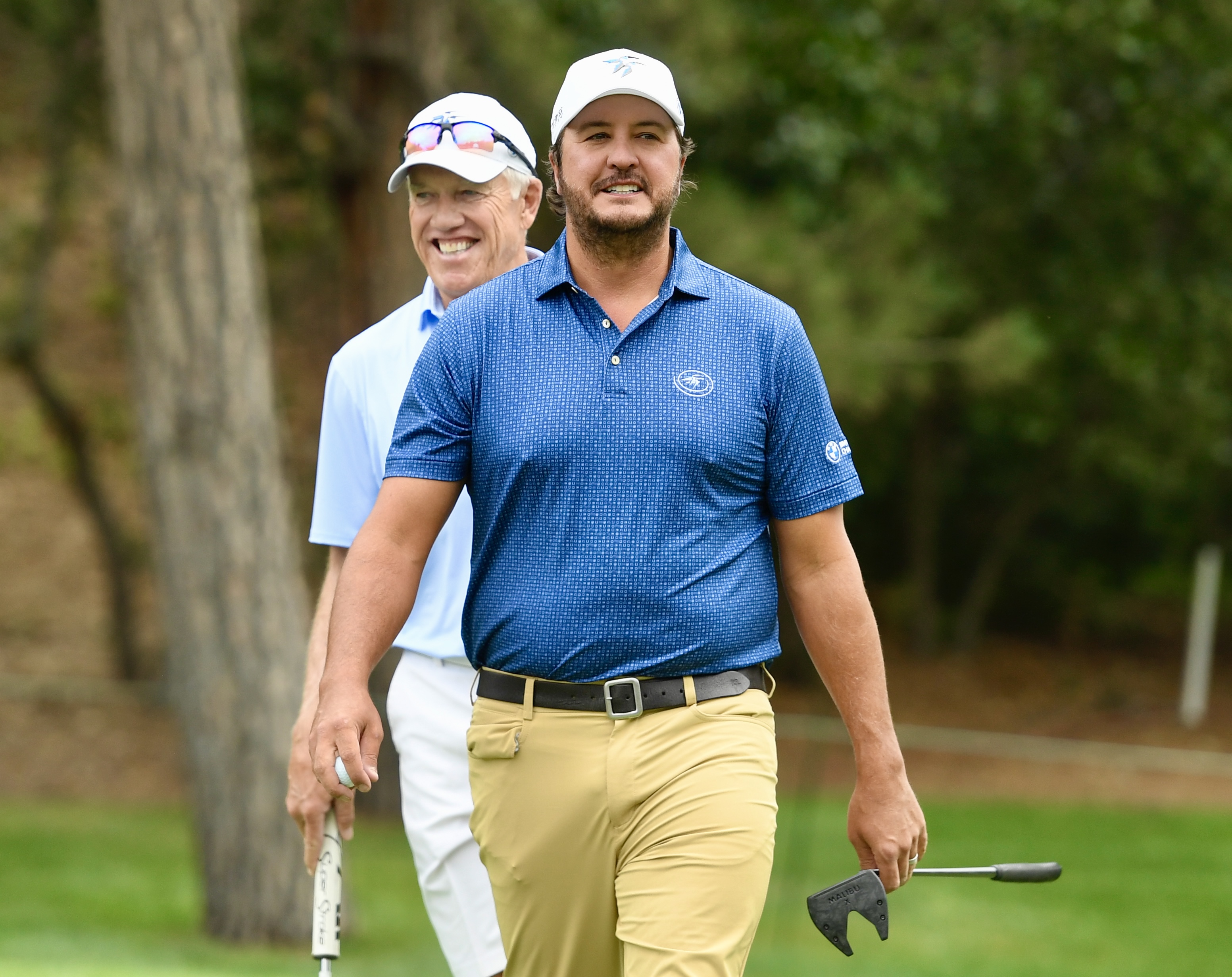 Country singer Luke Bryan walks off a green with John Elway at Castle Pines Golf Club at Wednesday's BMW Championship pro-am on Aug. 21, 2024. (CarsonFieldcarson.field@gazette.comhttps://secure.gravatar.com/avatar/c524ef3d384945349bed78d70eb2d2cd?d=mm&r=g)
