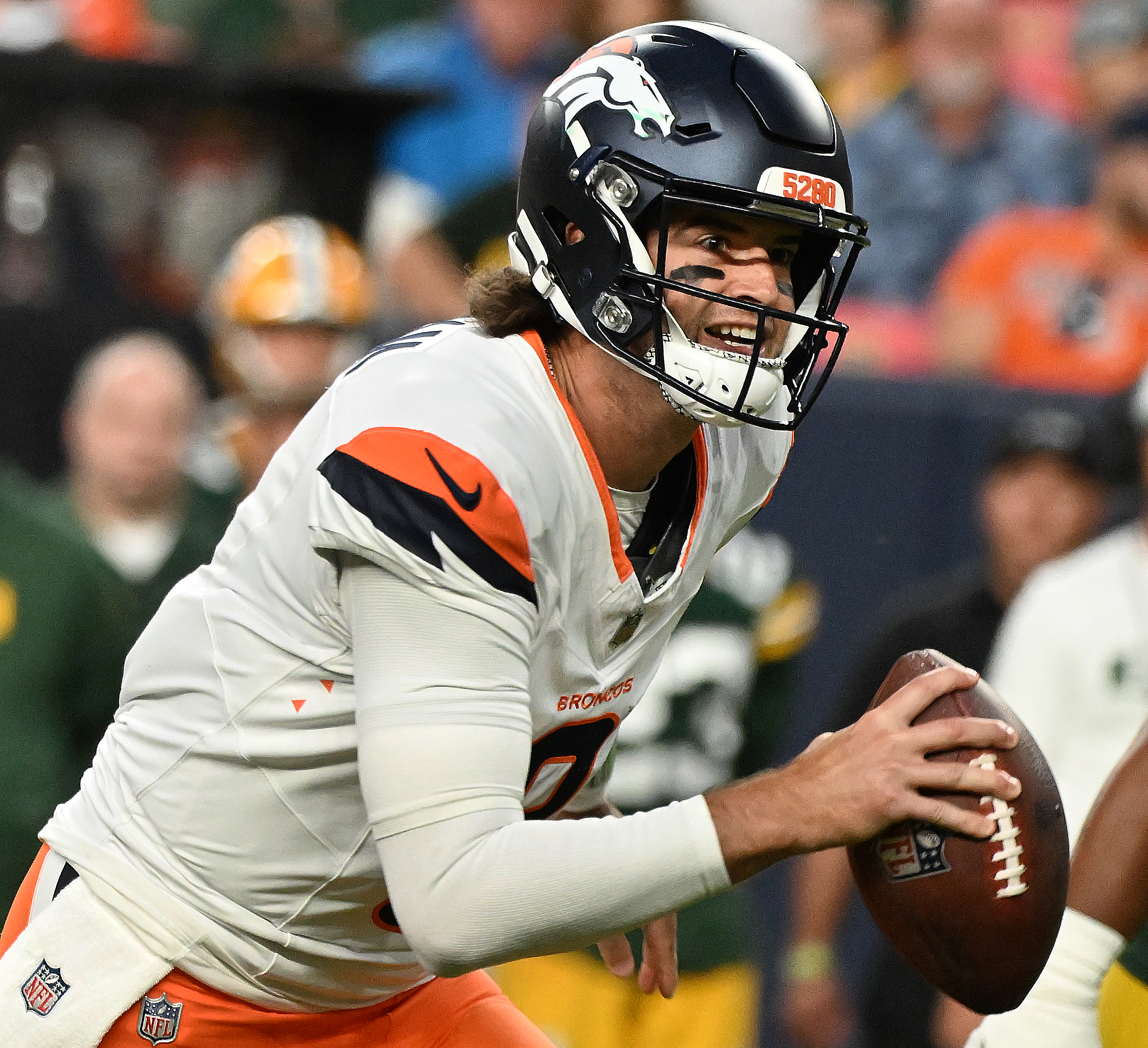 Denver Broncos quarterback Jarrett Stidham (8) is all smiles as he heads for the end zone during a preseason game against the Packers on Sunday, Aug. 18, 2024. The Broncos won the game 27-2. (Jerilee Bennett, The Gazette)