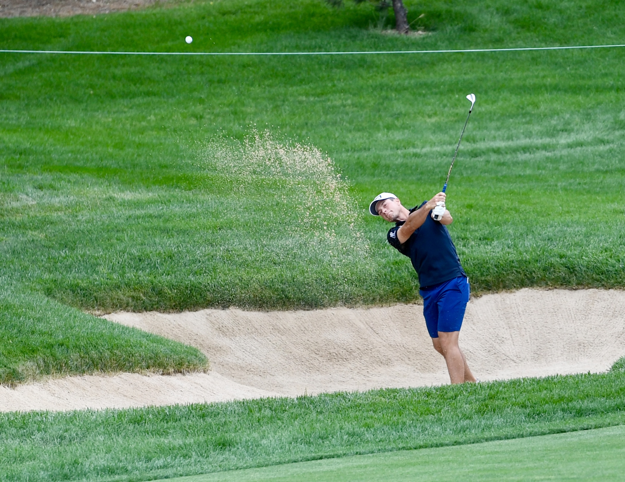 Viktor Hovland hits out of the sand at Castle Pines Golf Club at Wednesday's BMW Championship pro-am on Aug. 21, 2024. (CarsonFieldcarson.field@gazette.comhttps://secure.gravatar.com/avatar/c524ef3d384945349bed78d70eb2d2cd?d=mm&r=g)