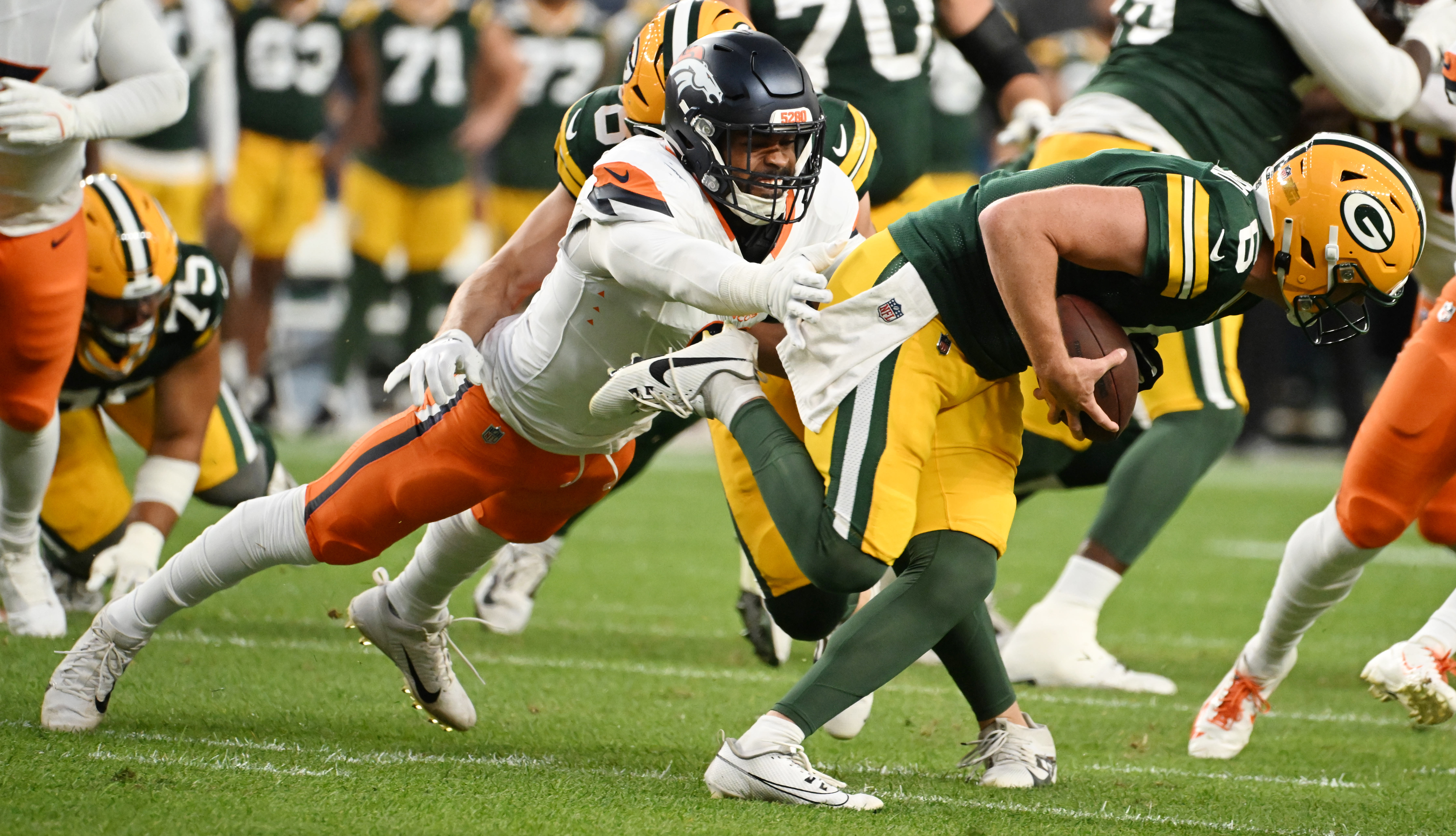 Denver Broncos linebacker Jonathon Cooper (0) goes after Packers quarterback Sean Clifford during a preseason game against the Packers on Sunday, Aug. 18, 2024. The Broncos won the game 27-2. (Jerilee Bennett, The Gazette)