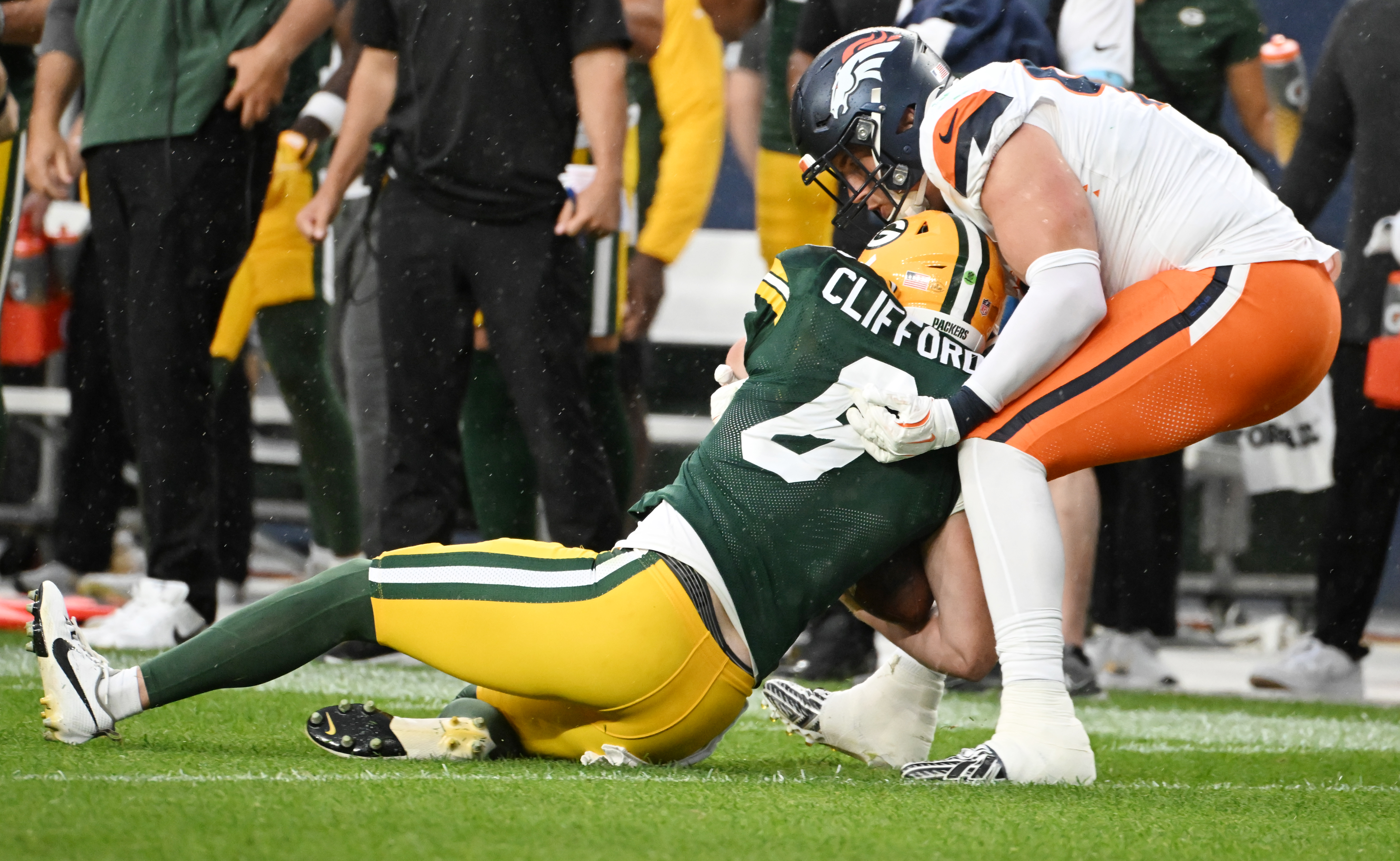 Broncos defensive end Zach Allen sacks Packers quarterback Sean Clifford during the second quarter of a preseason game against the Packers on Sunday, Aug. 18, 2024. (Jerilee Bennett The Gazette)