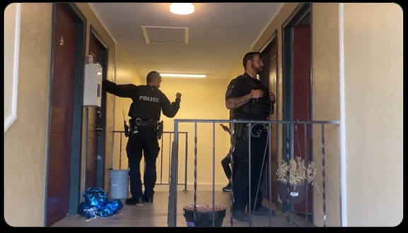 Two Aurora police officers check on apartment units in a video released by the city on Aug. 30. Aurora Interim Police Chief Heather Morris insists that gang members have not