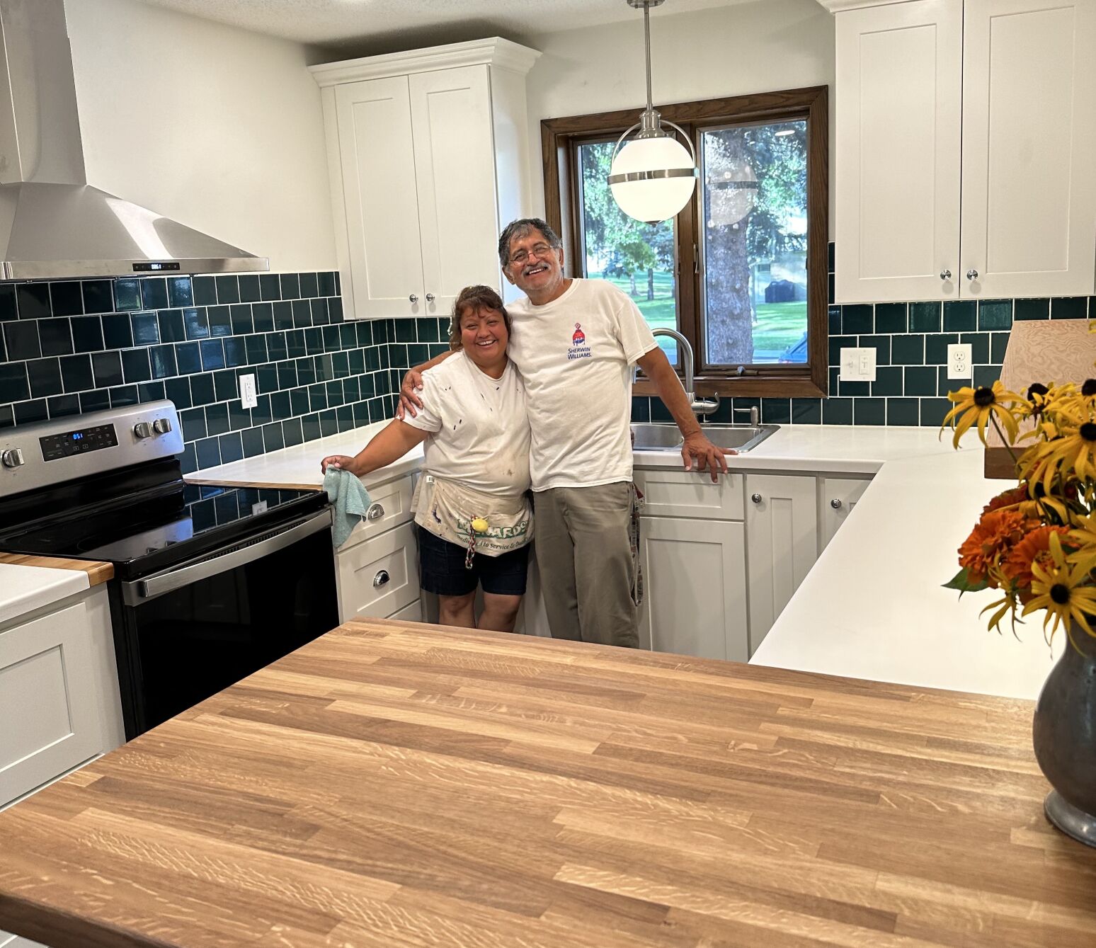 Leticia and Maynor Aldana stand in their new kitchen. “I’ve never had such nice appliances,” Leticia said. “Sometimes I’m afraid to turn them on.” (Courtesy of Bob Thacker)