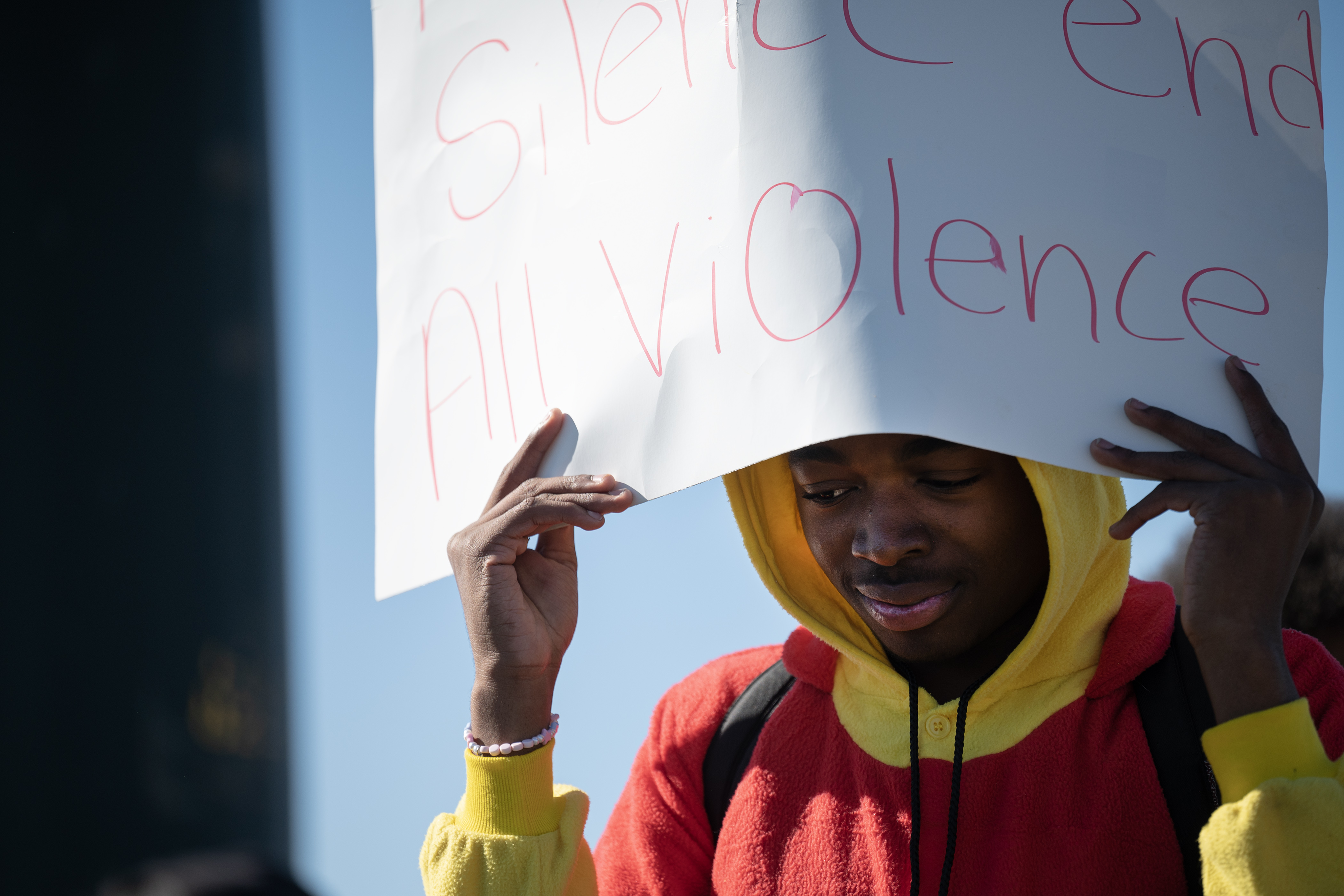 Dr. Martin Luther King, Jr. Early College freshman Kijuan Stepney, wearing a Winnie-the-Pooh costume for Halloween, carries a sign that reads “No More Silence End All Violence” as he and classmates march down Green Valley Ranch Boulevard during a student walkout in support of a student who was attacked outside of the school last Wednesday and in protest of youth violence policies in Denver Public Schools on Tuesday, Oct. 31, 2023, in Denver, Colo. (Timothy Hurst/Denver Gazette) (TimHursttim.hurst@gazette.comhttps://secure.gravatar.com/avatar/aca82bd62b4ee425c598527cd6faa1b1?d=mm&r=g)
