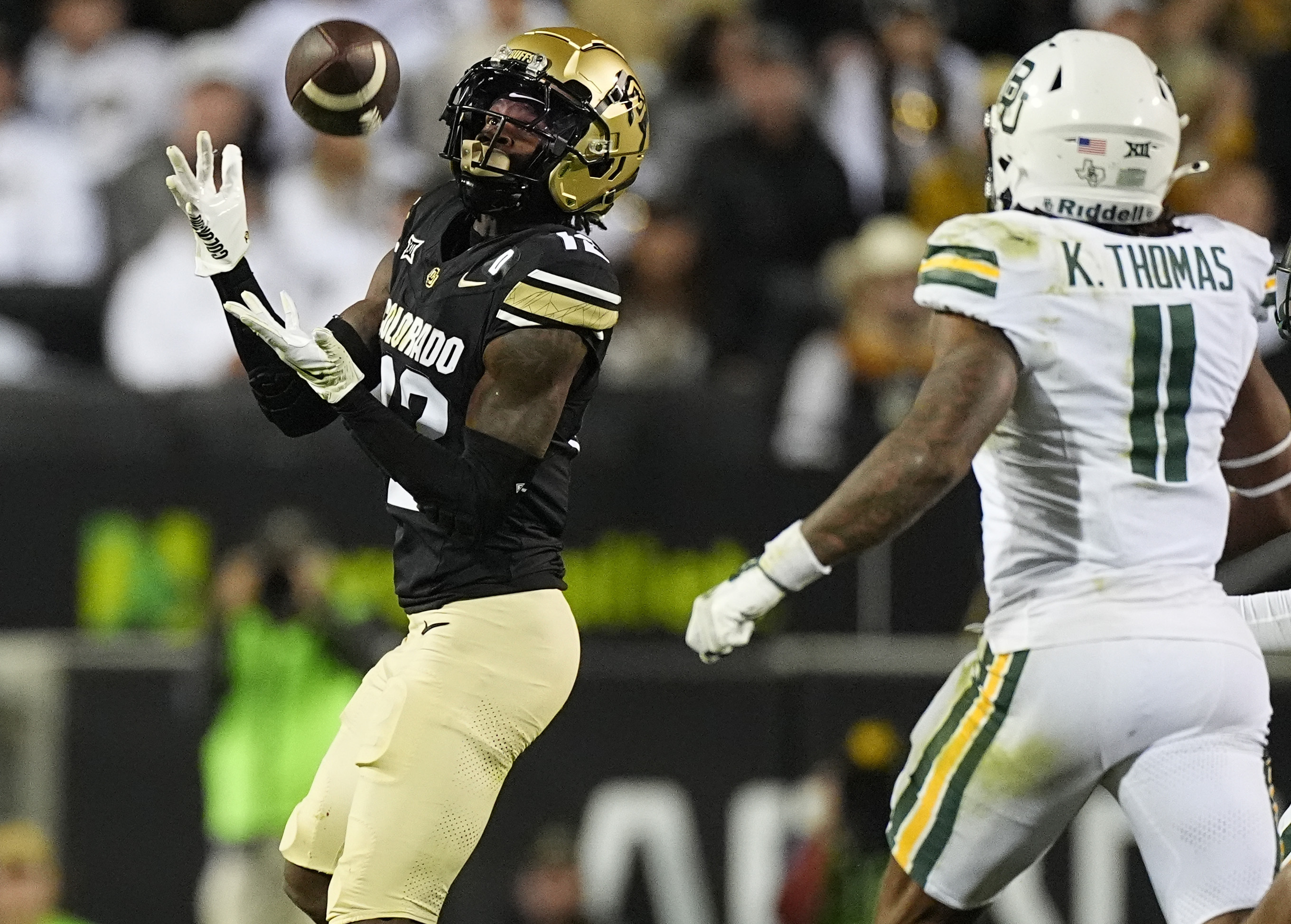 Colorado wide receiver Travis Hunter, left, pulls in a pass as Baylor linebacker Keaton Thomas defends in the second half of an NCAA college football game Saturday, Sept. 21, 2024, in Boulder, Colo. (AP Photo/David Zalubowski) (David Zalubowski)
