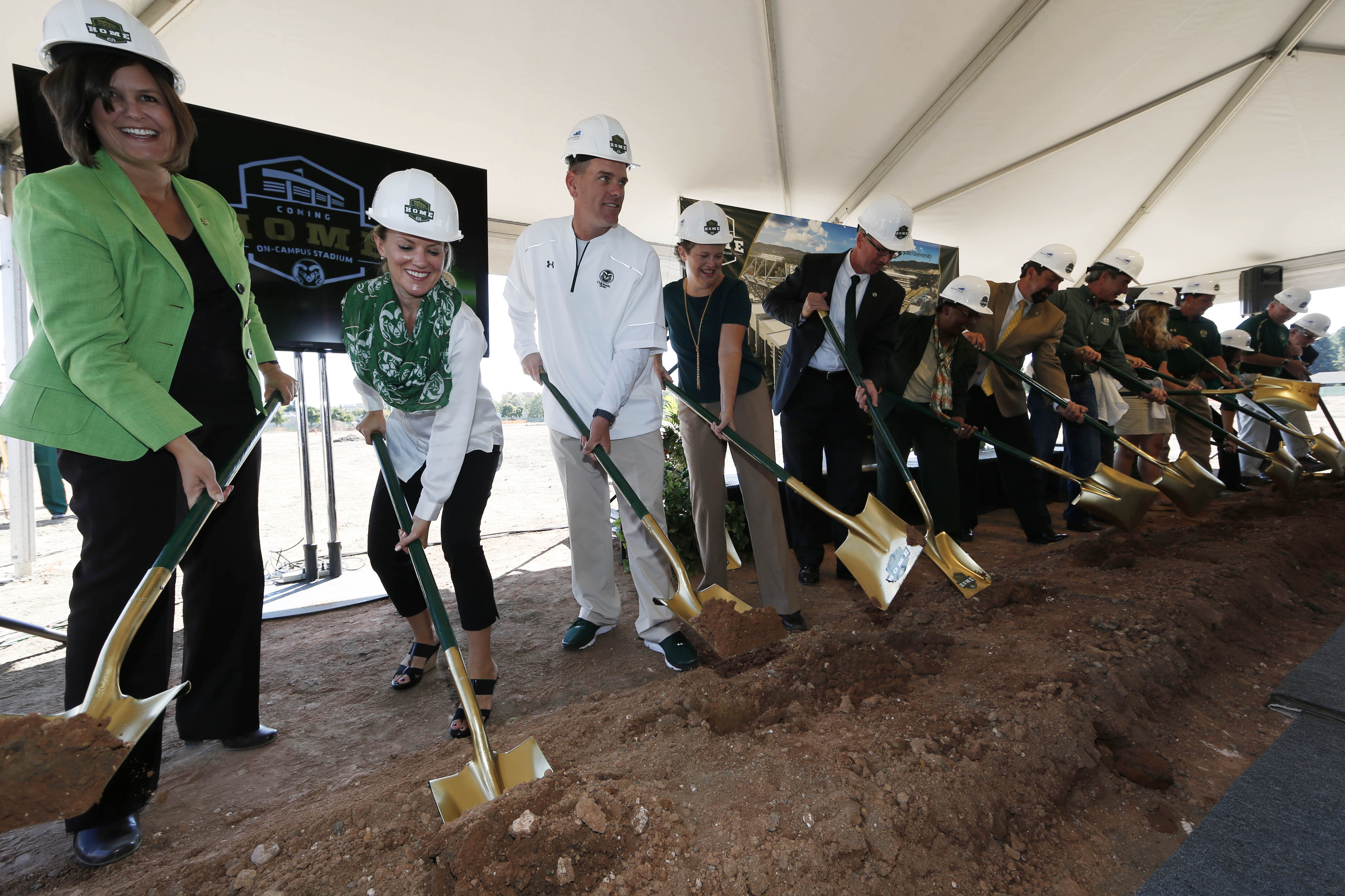 From left, Kristi Bohlender, executive director of Colorado State University Alumni Association, joins Amy Parsons, vice president of university operations and co-chair of stadium advisory committee, and head football coach Mike Bobo and others during a ceremonial groundbreaking at Colorado State to mark construction of an on-campus, multiple use facility that will include a new football stadium Saturday, Sept. 12, 2015, in Fort Collins, Colo. The stadium is projected to be ready for the Rams' 2017 season. (AP Photo/David Zalubowski) (David Zalubowski)