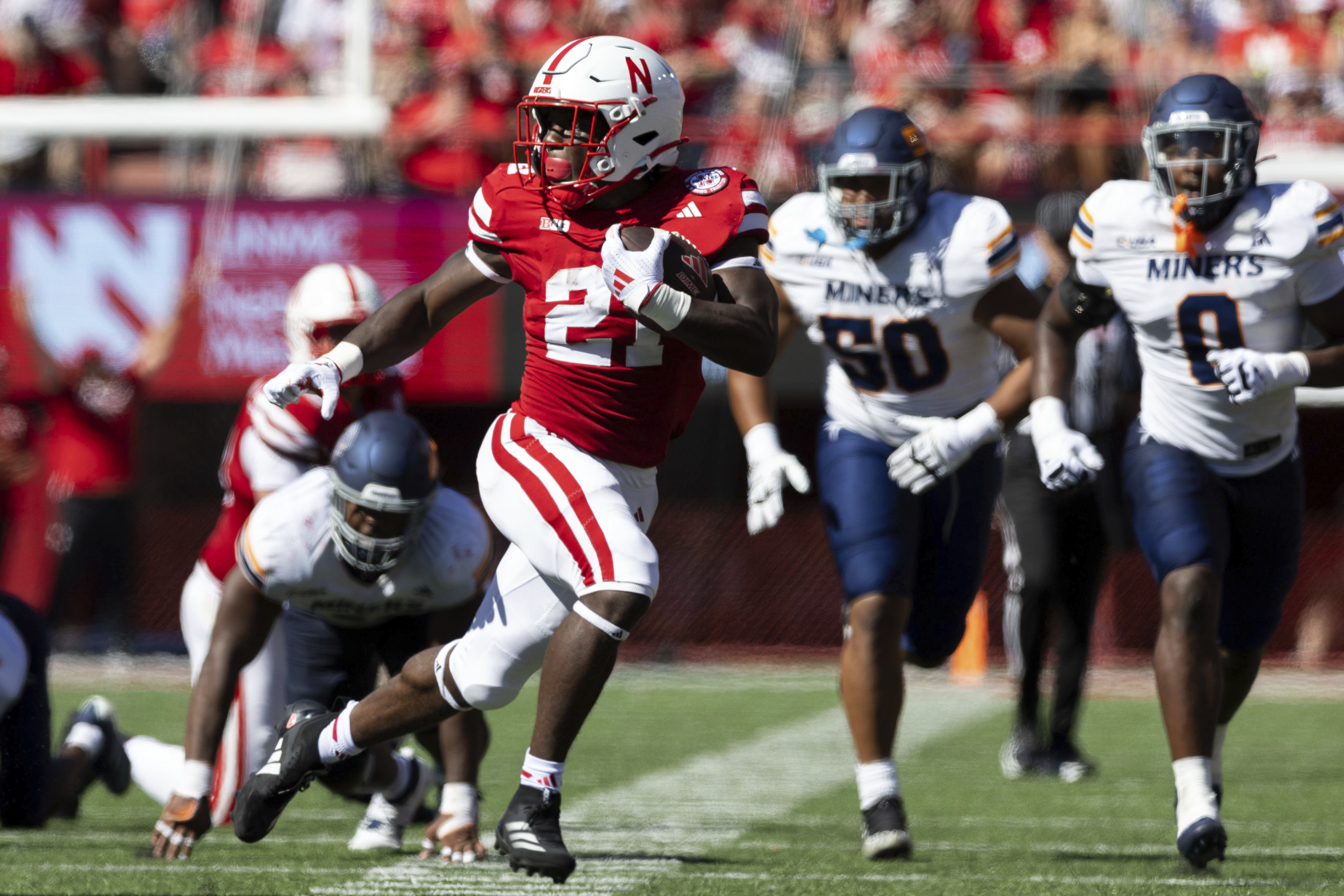Nebraska's Emmett Johnson (21) runs the ball for 42 yards during the first half of an NCAA college football game against UTEP in Lincoln, Neb., Saturday, Aug. 31, 2024. (Chris Machian/Omaha World-Herald via AP) (Chris Machian)