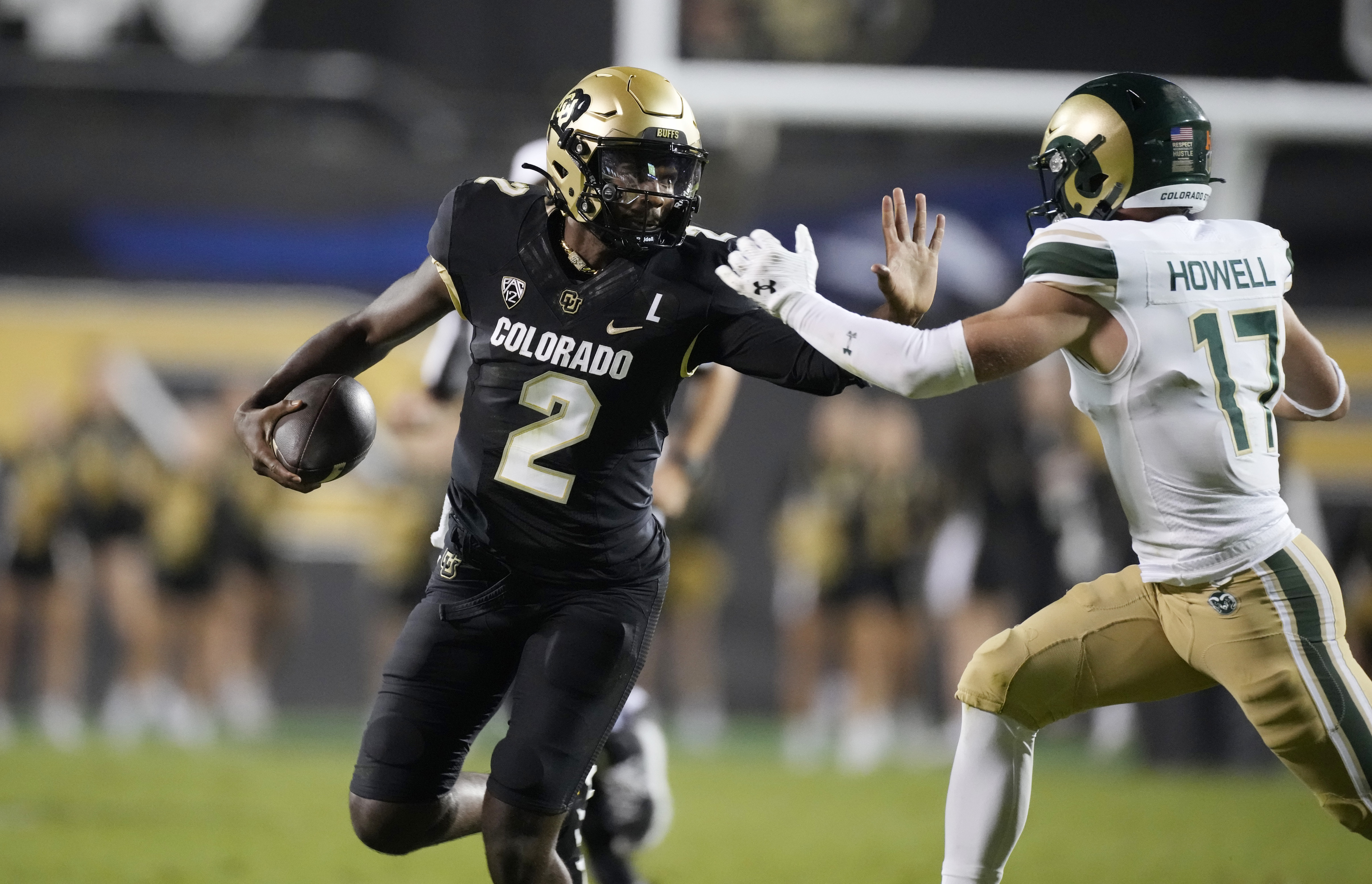 Colorado quarterback Shedeur Sanders (2) and Colorado State defensive back Jack Howell (17) in the second half of an NCAA college football game Saturday, Sept. 16, 2023, in Boulder, Colo. (AP Photo/David Zalubowski) (David Zalubowski)