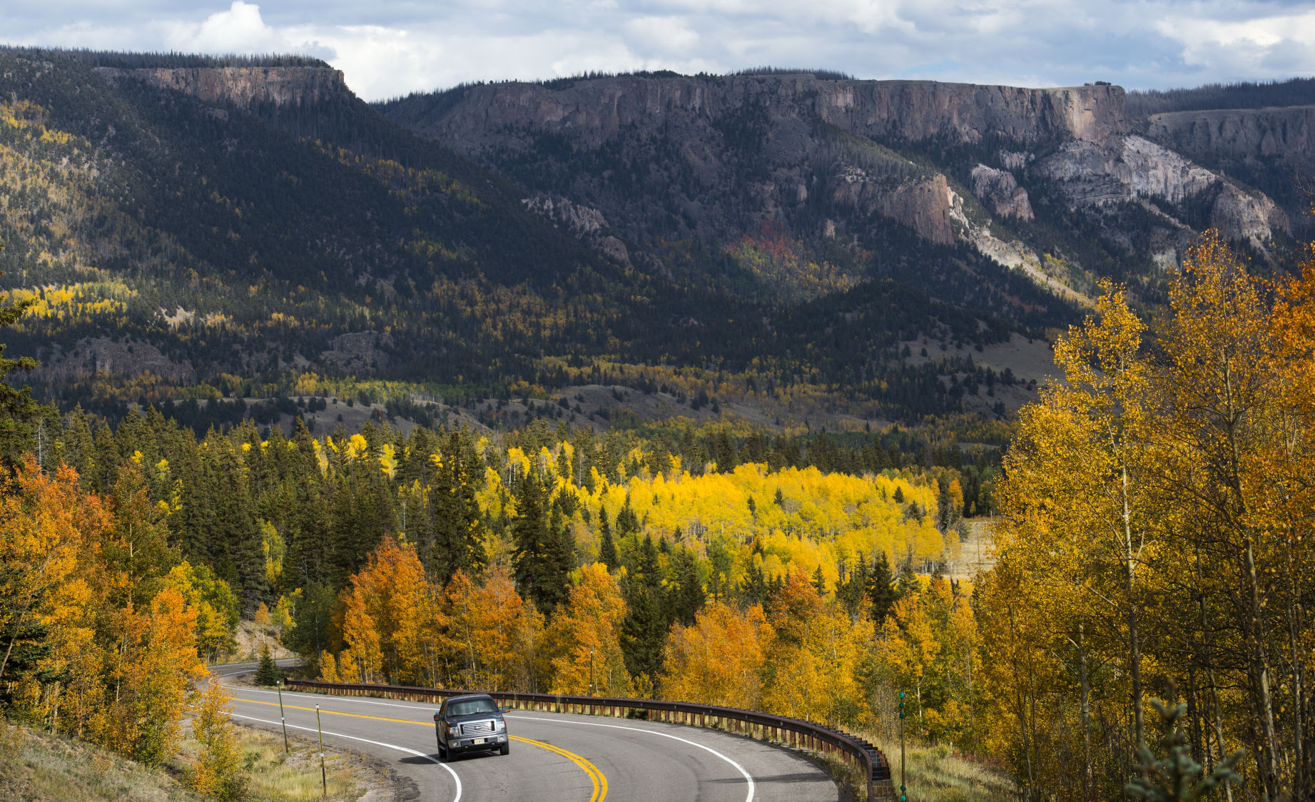 A truck drives north toward Lake City on Colorado 149 near Spring Creek Pass as the aspens show their colors on Sunday, Sept. 16, 2018. (CHRISTIAN MURDOCK THE GAZETTE)