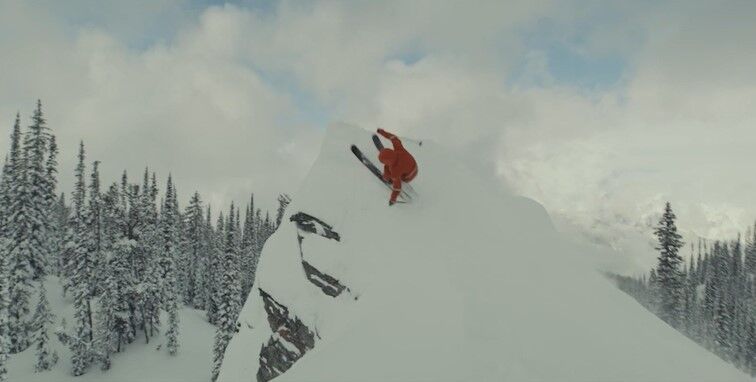 A skier skis up a rock before jumping off it in Warren Miller Entertainment's ski movie '75'. (Courtesy, Warren Miller Entertainment)