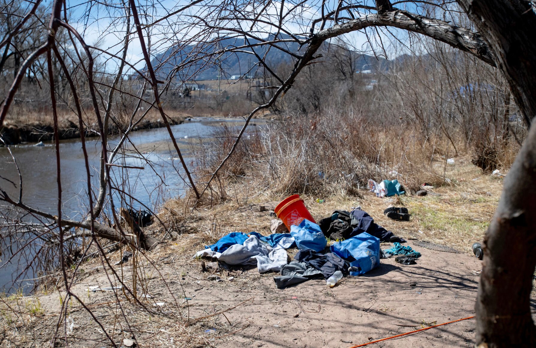 Piles of trash, clothing, personal belongings and other remnants of a large homeless encampment are sprawled across the western bank of Fountain Creek along the Greenway Trail in April. Colorado Springs is hiring four new park rangers to help with address concerns about homelessness along trails and respond to other citizen complaints. Parker Seibold, The Gazette (Parker Seibold, The Gazette)